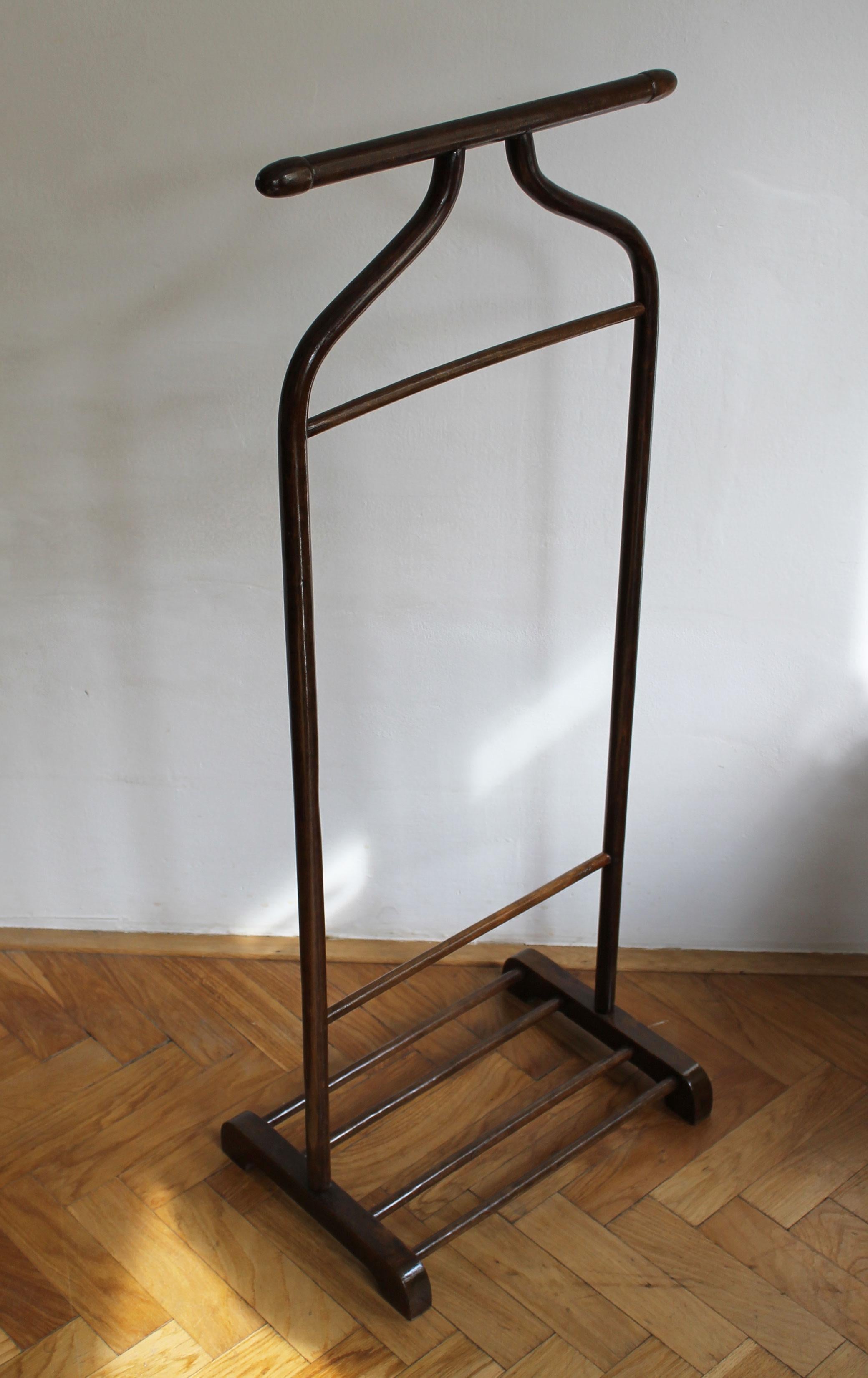 This is an original 1920's Gentleman's Valet Stand that the Thonet Company was selling as Model P133. 

This piece, commonly referred to as the “ Furniture Servant” is made of a dark brown stained beechwood and was designed to comfortably hold a