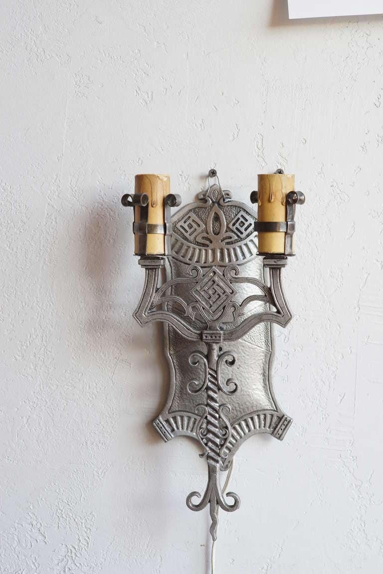 Vintage 1920s geometric Art Deco aluminum wall sconces with intricate scroll work.

Stamped 