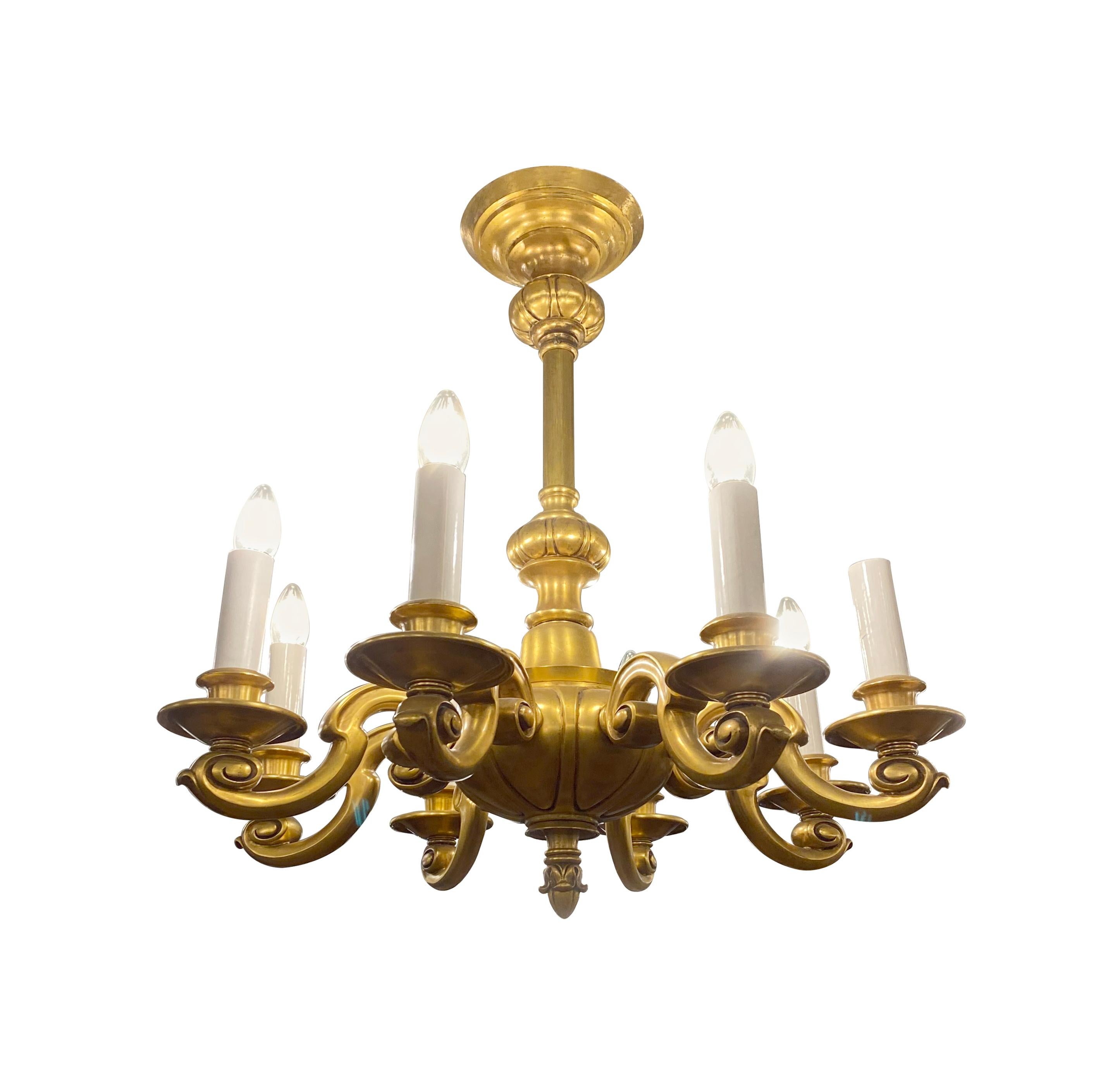 20th Century gilded bronze chandelier designed in a Georgian style with eight arms and an ornate acorn finial. Cleaned and rewired. Takes eight standard household medium base lightbulbs. Please note, this item is located in one of our NYC locations.
