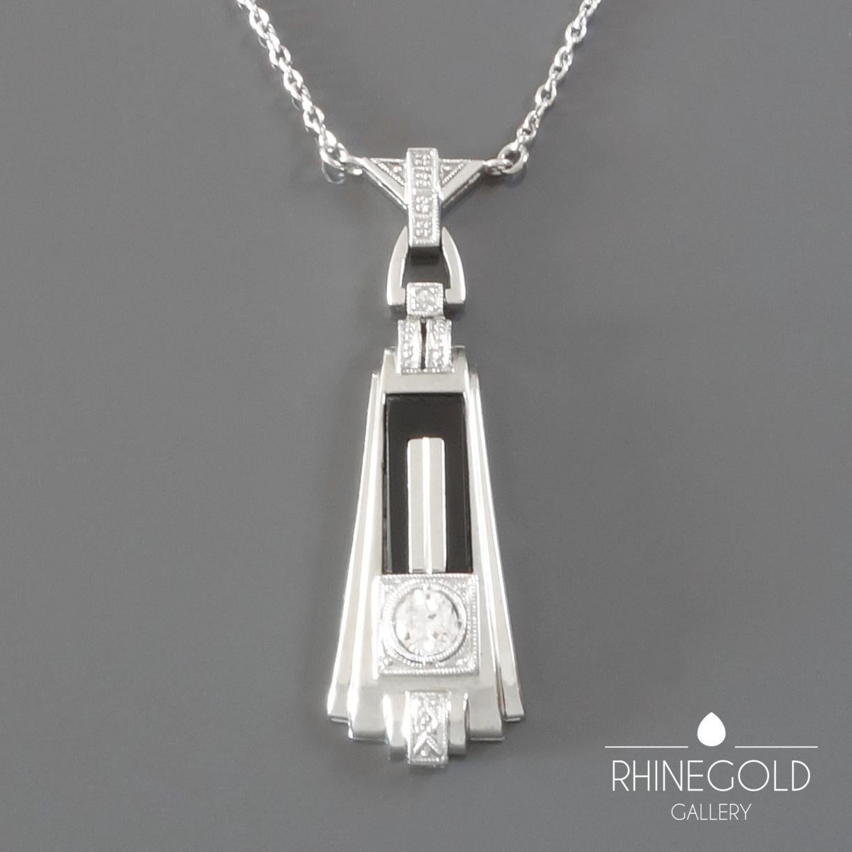 1920s German Art Deco Diamond Onyx White Gold Pendant Necklace
18k white gold (pendant), 14k white gold (chain), old European cut diamond (approx. 0.2 carat; H; vvs2), onyx
Pendant 3.5 cm by 1.1 cm (approx. 1 3/8” by 7/16”); chain 42.3 cm (approx.