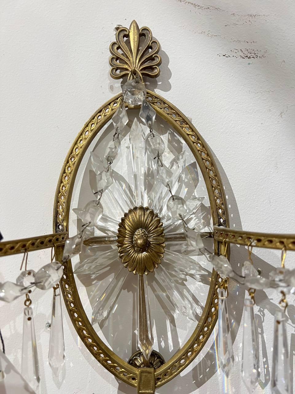 A pair of circa 1920’s Caldwell sunburst sconces with crystals. Available in silver plate