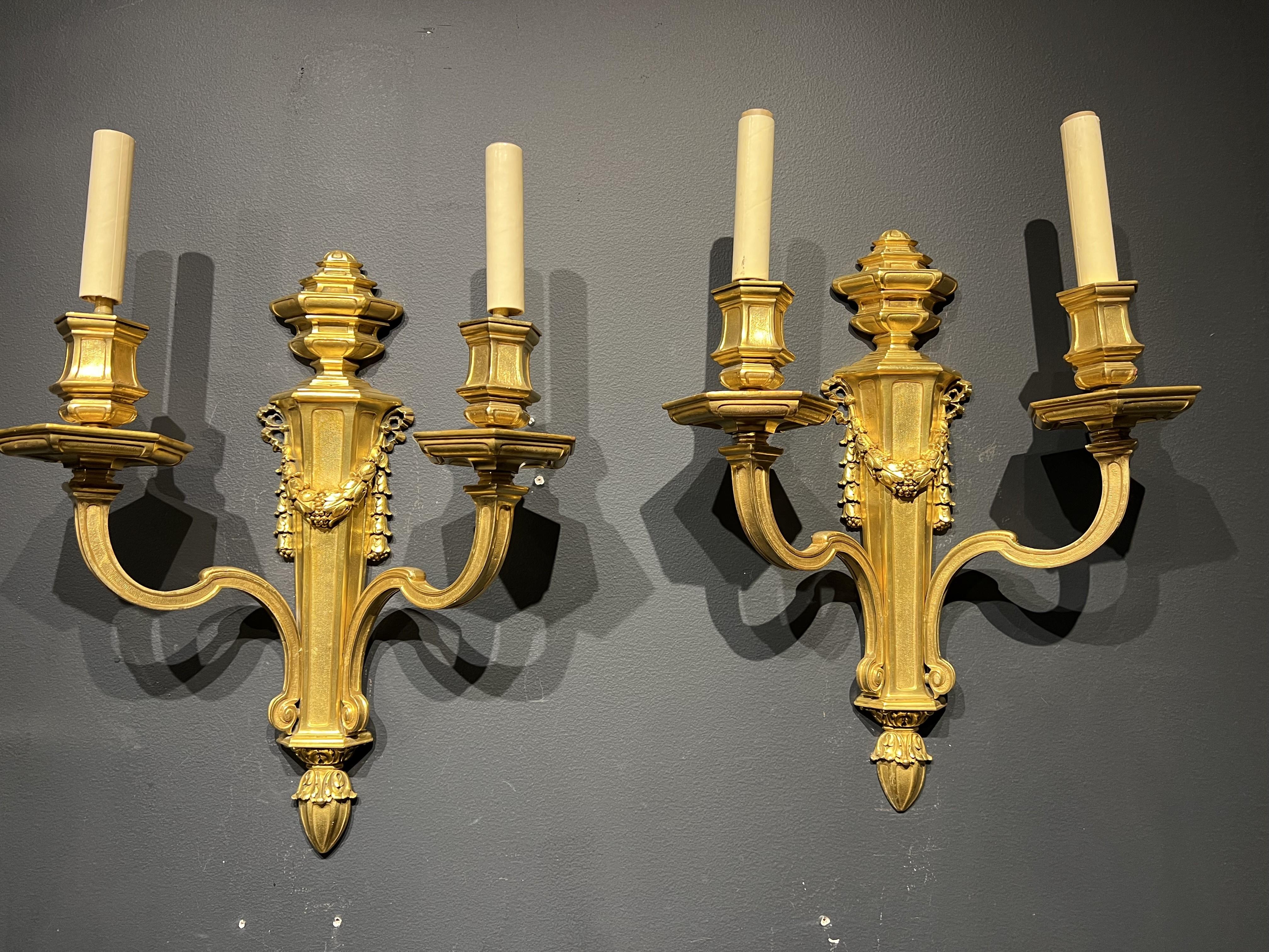 A pair of circa 1920's Caldwell gilt bronze sconces with two lights