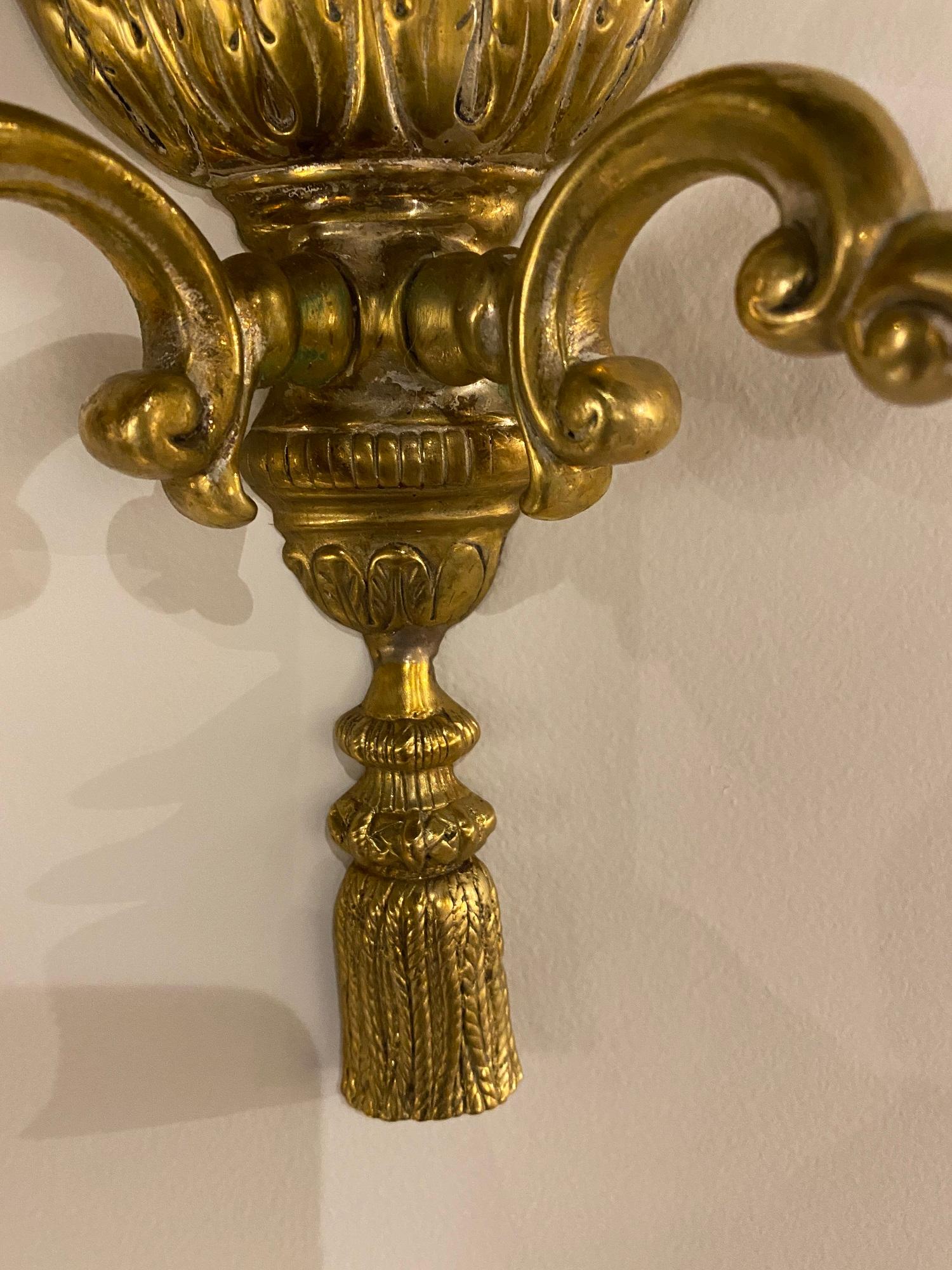 A pair of 1920's gilt bronze two lights sconces with acanthus leaves design 