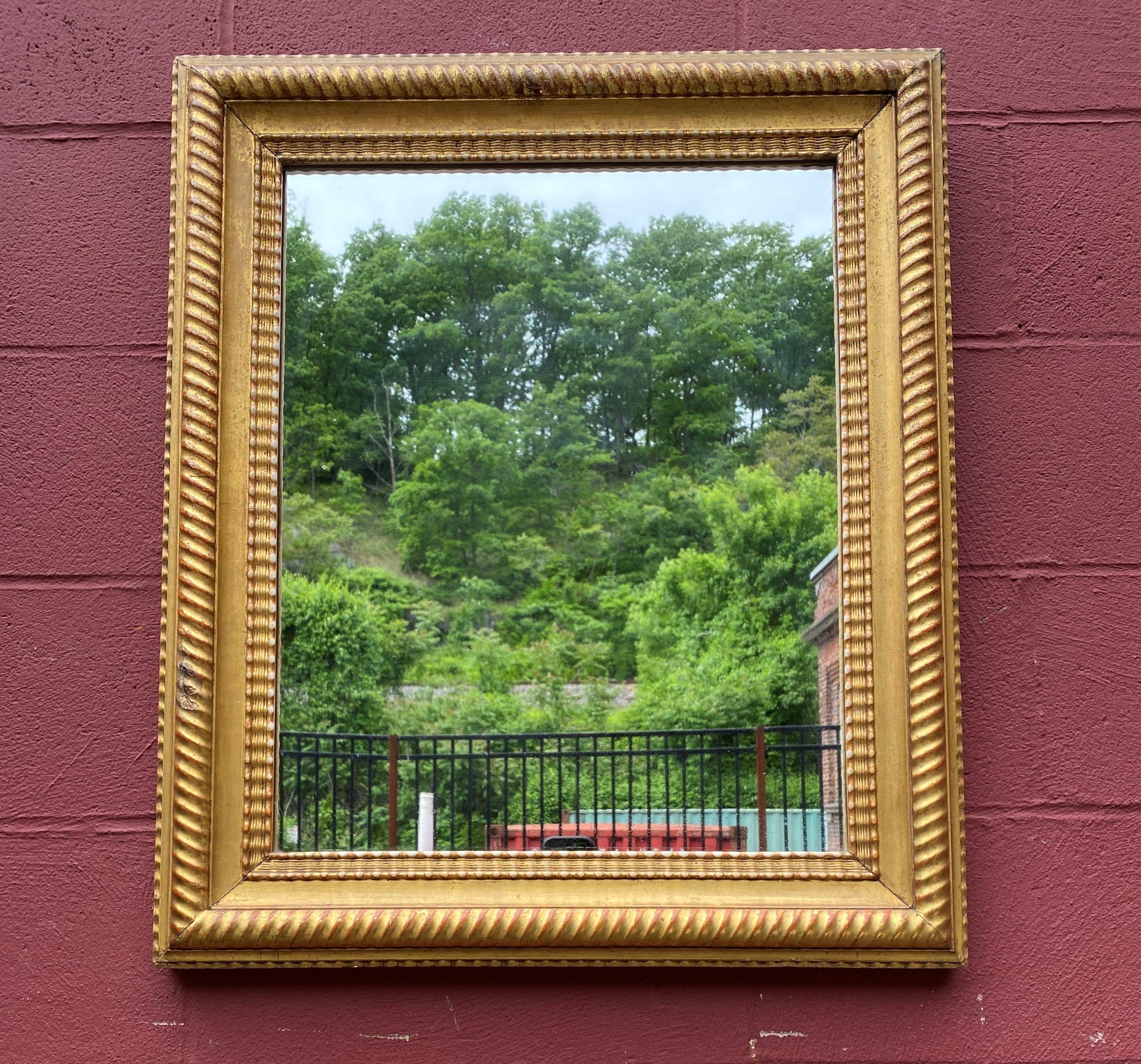 French  gilt wood mirror with original wood back dating back to early 1900’s. This mirror can  be hung horizontally or vertically is is very well made. Good vintage condition appropriate with age. 

Ref #: DM0321-05

Dimensions: 30”H x 25.25