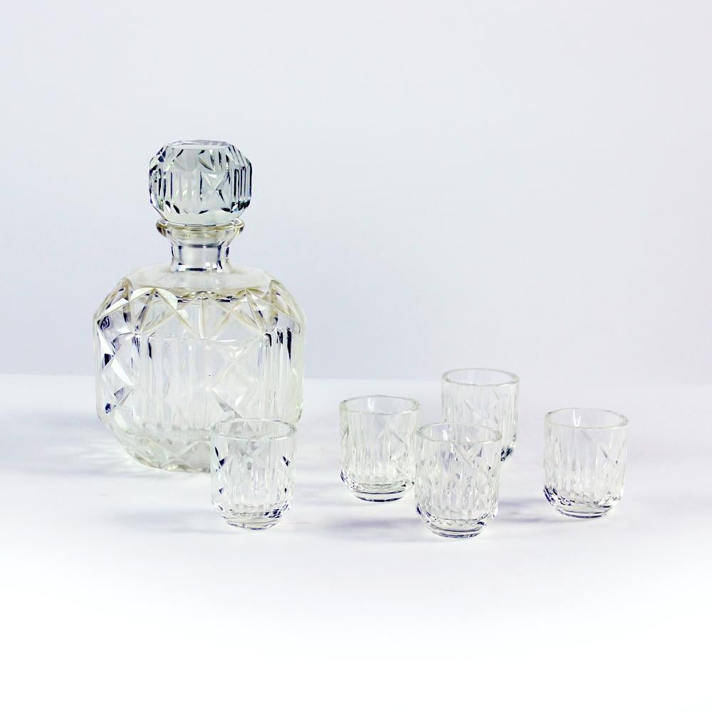 Beautiful antique set of alcohol bottle and 5 shots. All produced in 1920s in Czechoslovakia. Produced in heavy glass with engraved details and pattern. The bottle is heavy and really beautiful with elegant shape and strong design. Shots are great
