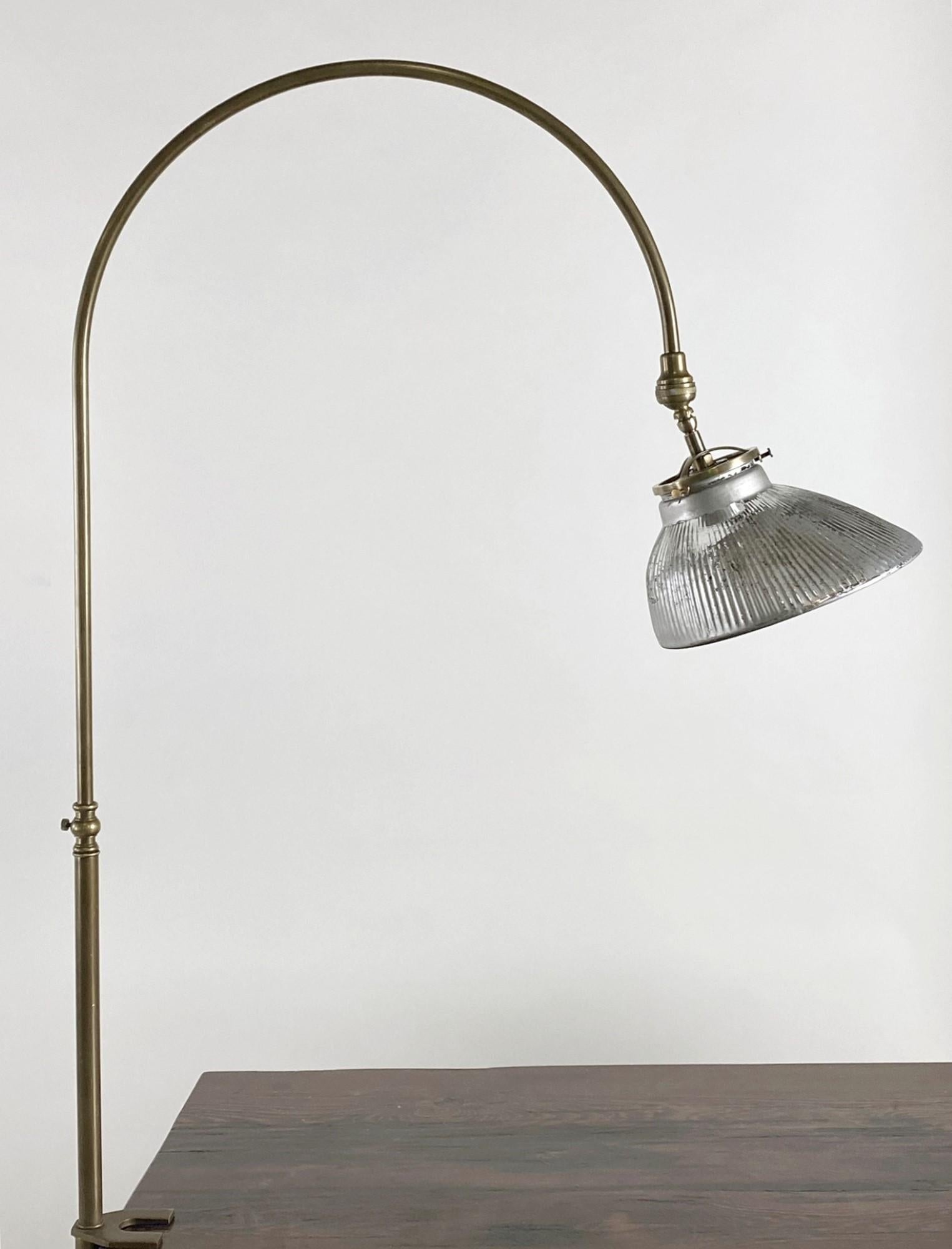 1920s brass gooseneck desk lamp made with a mercury glass shade. Features a 10 foot cord with a thumb on/off switch. Uses a normal household light bulb. Small quantity available at time of posting. Priced each. This can be seen at our 400 Gilligan