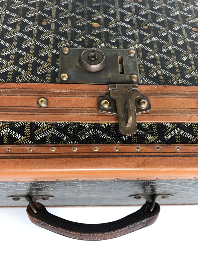 A 1940's Goyard vanity case with matching suitcase, each with tan leather  mounts, the vanity case wi