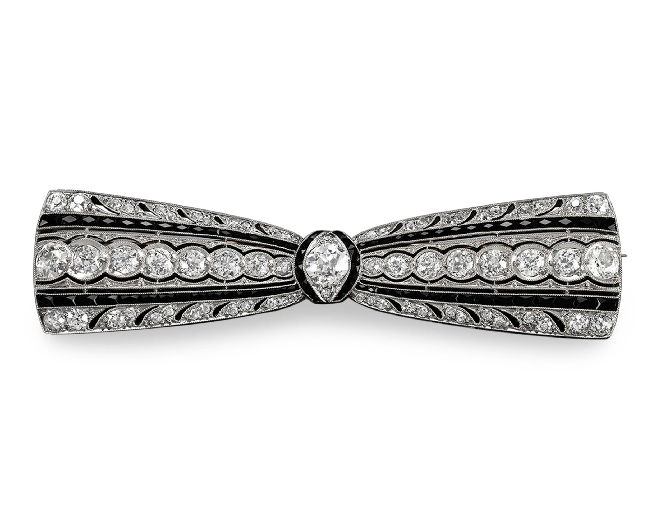 Seventy-one sparkling white diamonds and faceted black onyx make an elegant statement in this Art Deco-period 