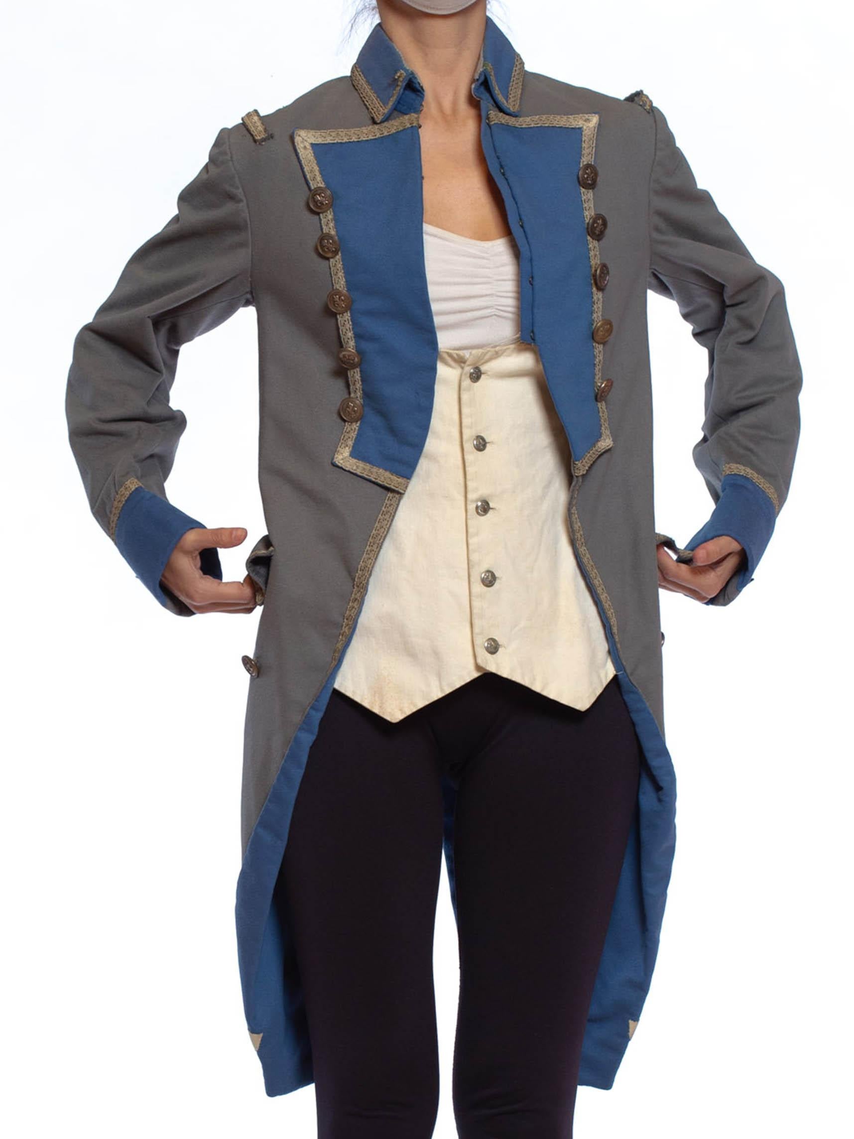 The white waistcoat is faux and can be removed. Some small stains and holes. Cool antique French Fleur-de-lis buttons. 1920S Grey & Blue Wool 18Th Century Style Military Frock Coat 