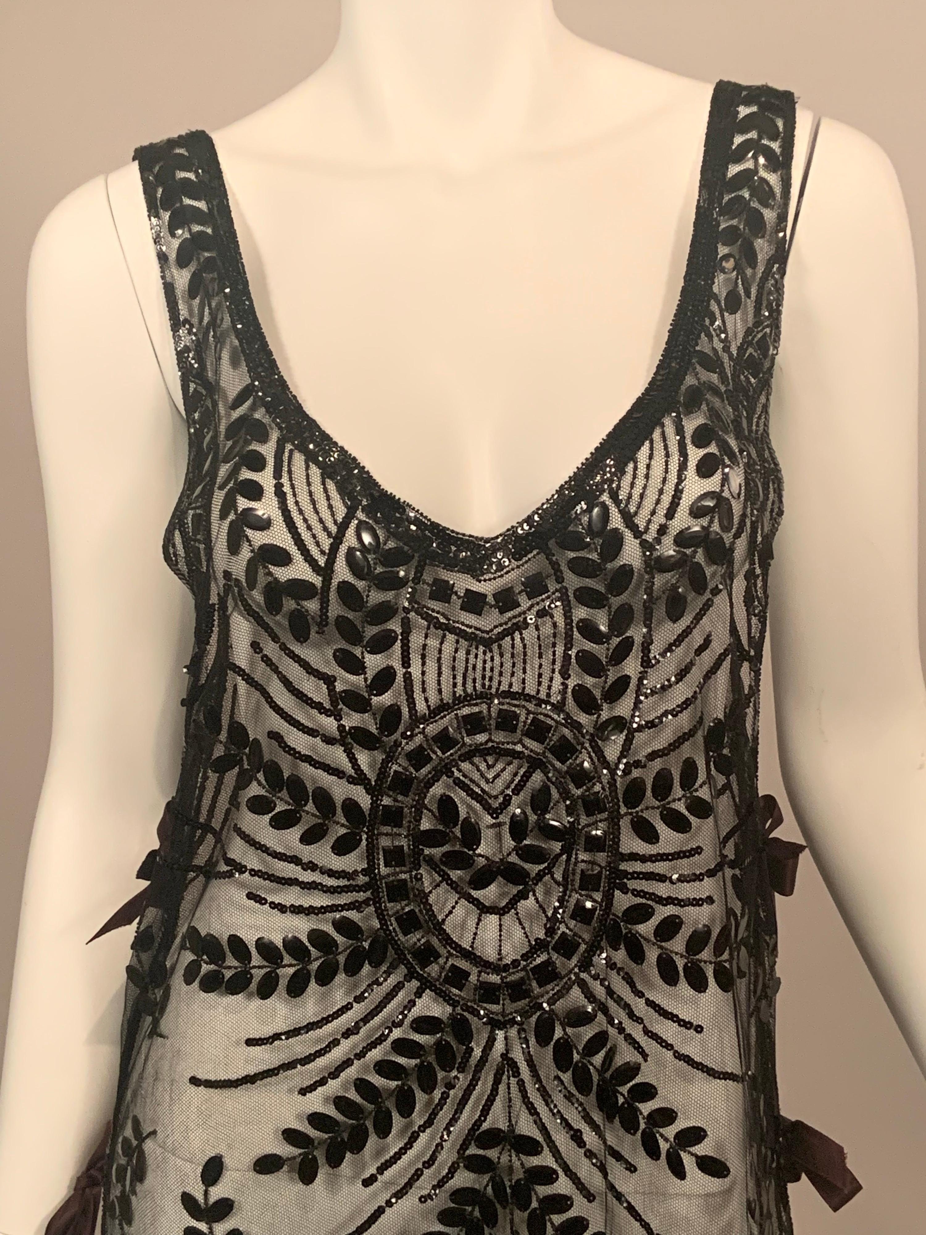 This is one of the very best beaded tabards that I have had the pleasure to offer for sale in a long time.  The dress is in amazing condition!  Made from black cotton net it is covered with a pattern of black leafy branches with large oval sequins