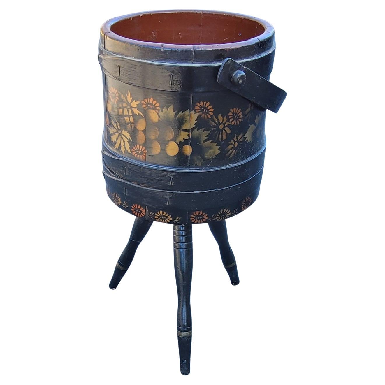 A 1920s hand-crafted, hand painted and Decorated Tripod Firkin or Sewing Bucket with handle.
Newer paint job with flowers.
 