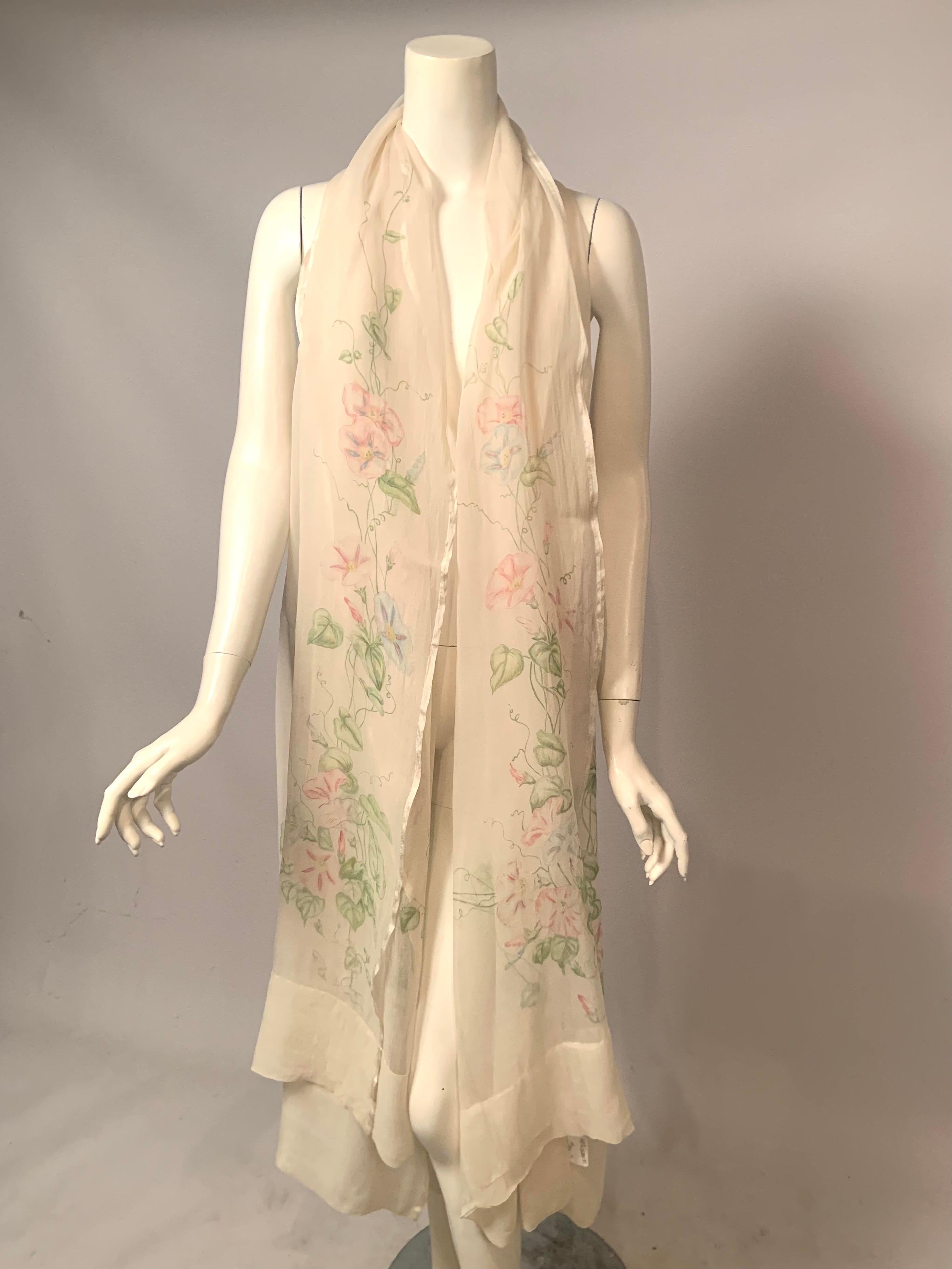 This 1920's hand painted floral silk chiffon shawl is just stunning!  The creamy white silk chiffon is hand painted with meandering Morning Glory flowers and vines on all four sides of the shawl. The vines and leaves are painted in several soft