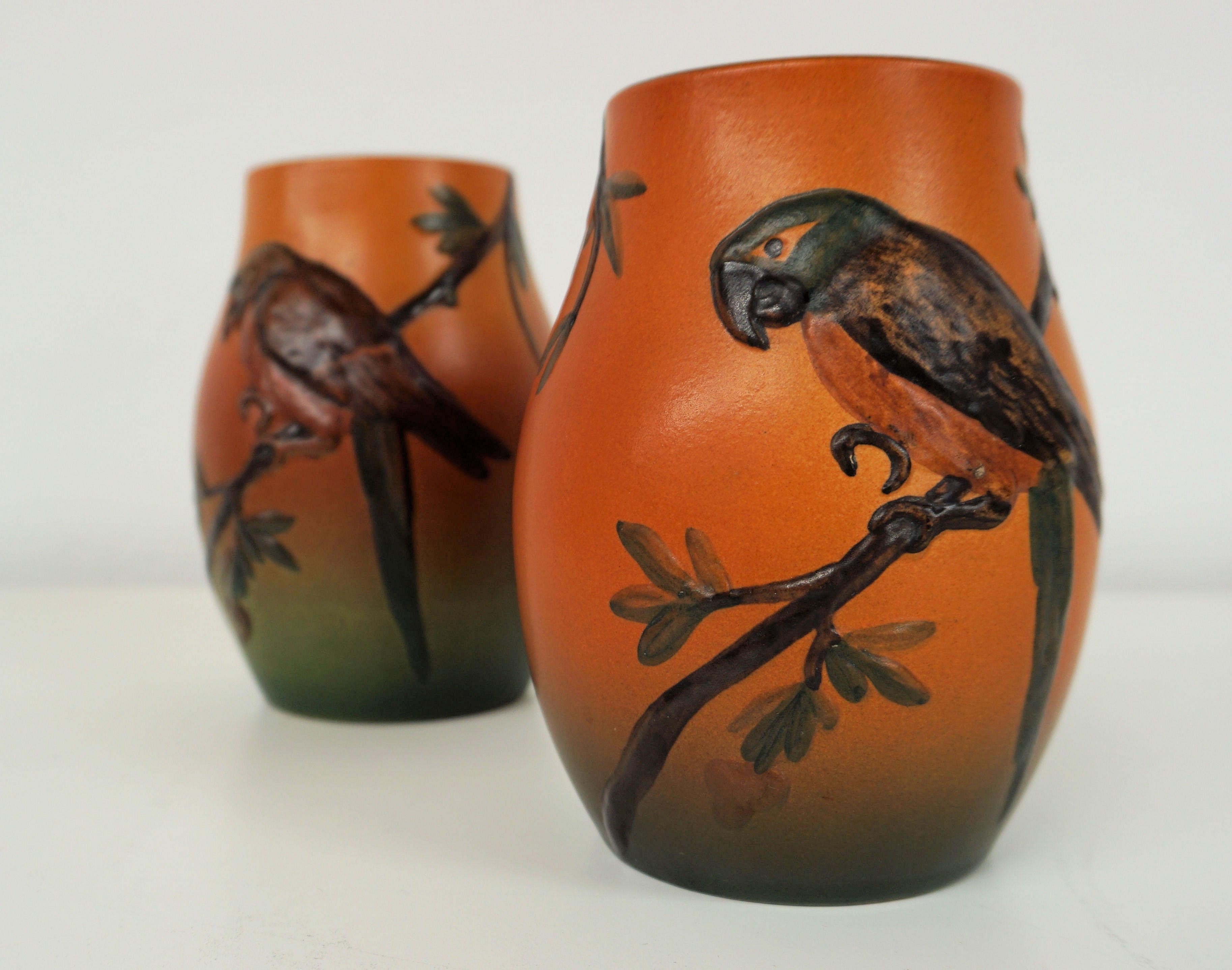 Hand-crafted Danish Art Nouveau flower decorated vases by West in 1927 for P. Ipsens Enke

The art nouveau vases feature very well made lively parrot with branches and leafs are in very good condition.

P. Ipsens Enke (1843 - 1955) was a very