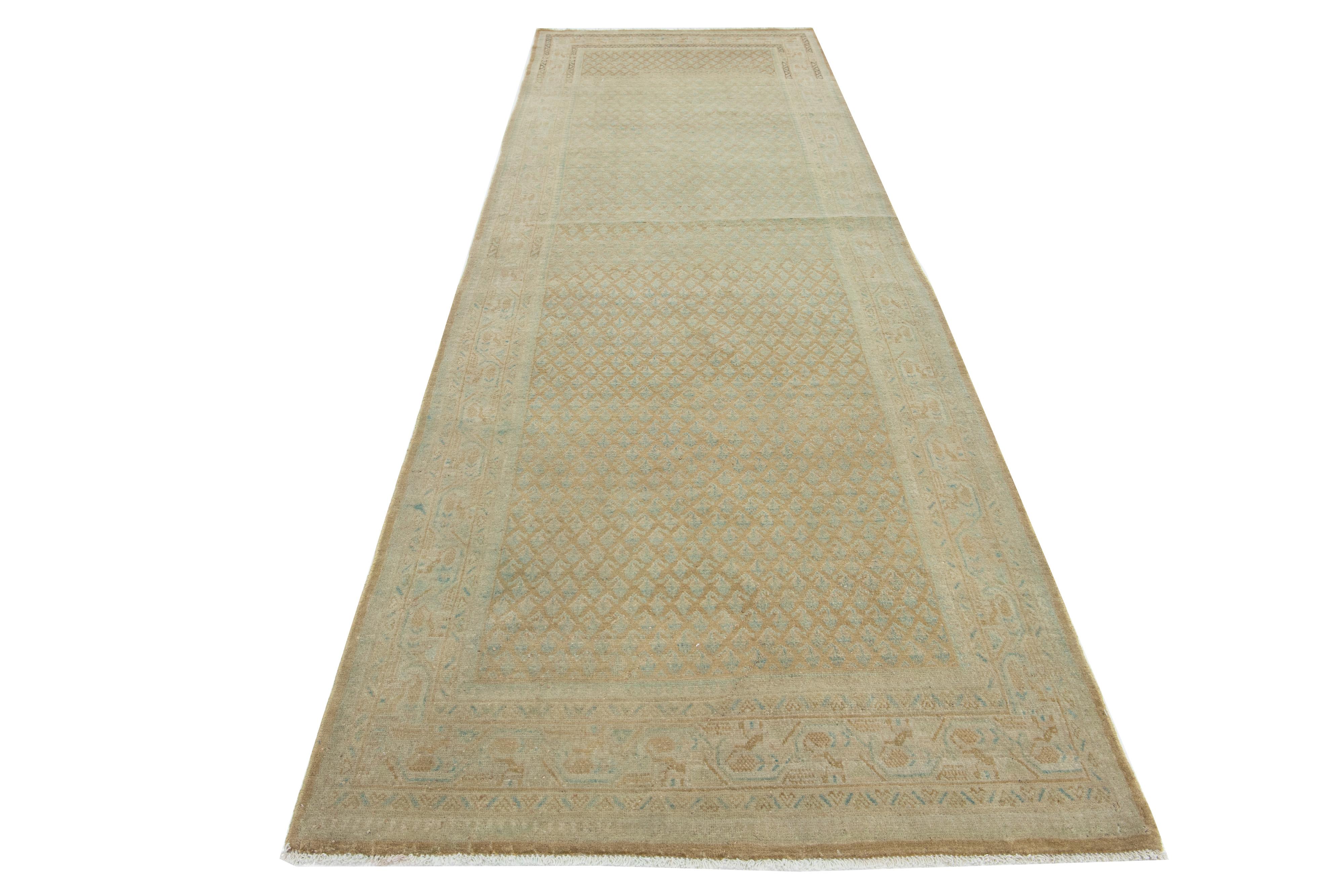 This is a handmade Persian Malayer wool rug from the 20th century. It features a blue field with brown and beige accents throughout the design.

This rug measures 3'9