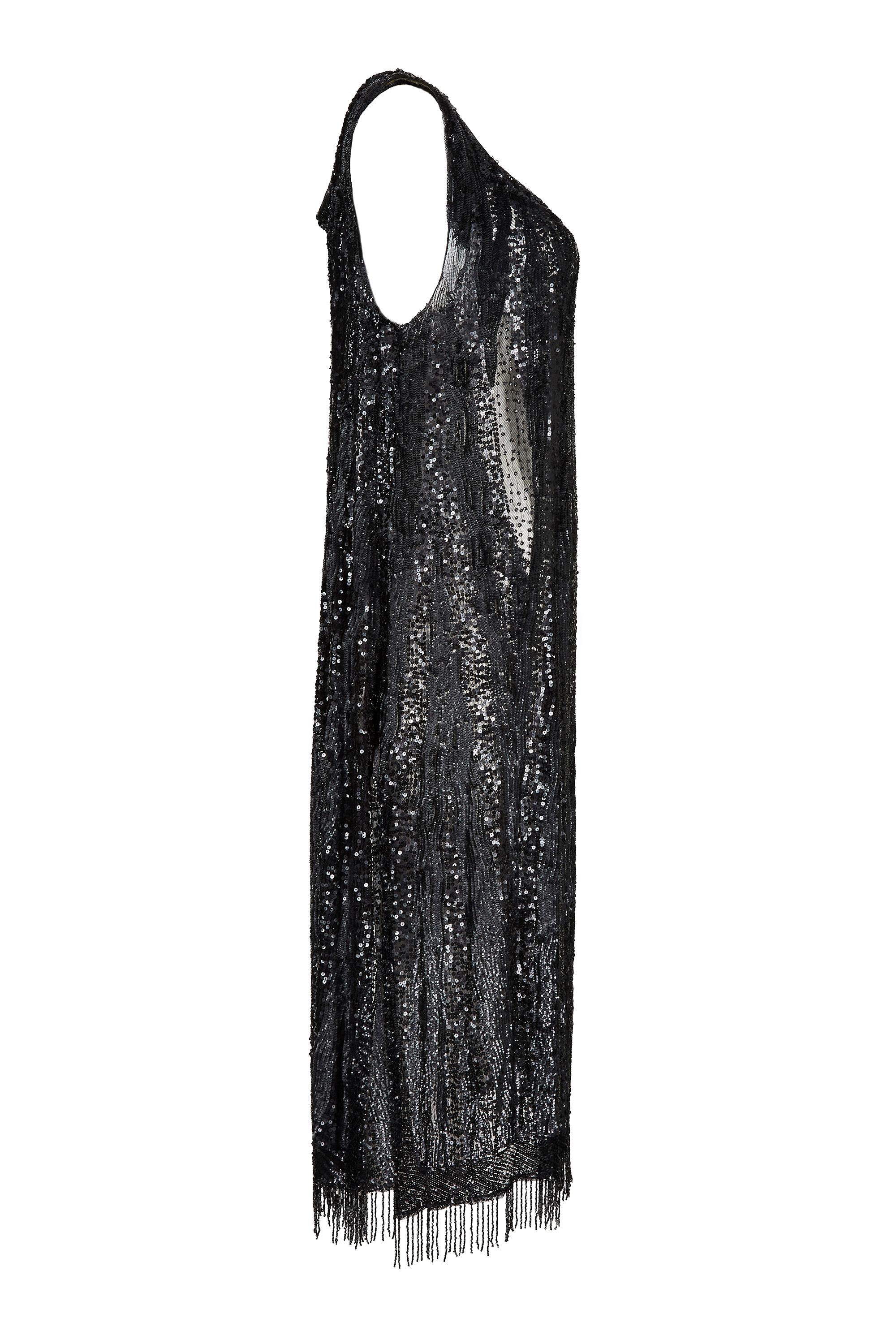 This original 1920s little black dress is an unlabelled haute couture example, fully sequinned all over and in truly excellent antique condition. Tailored to a timeless flapper silhouette, this exquisite tabard gown has a gentle scope neckline,