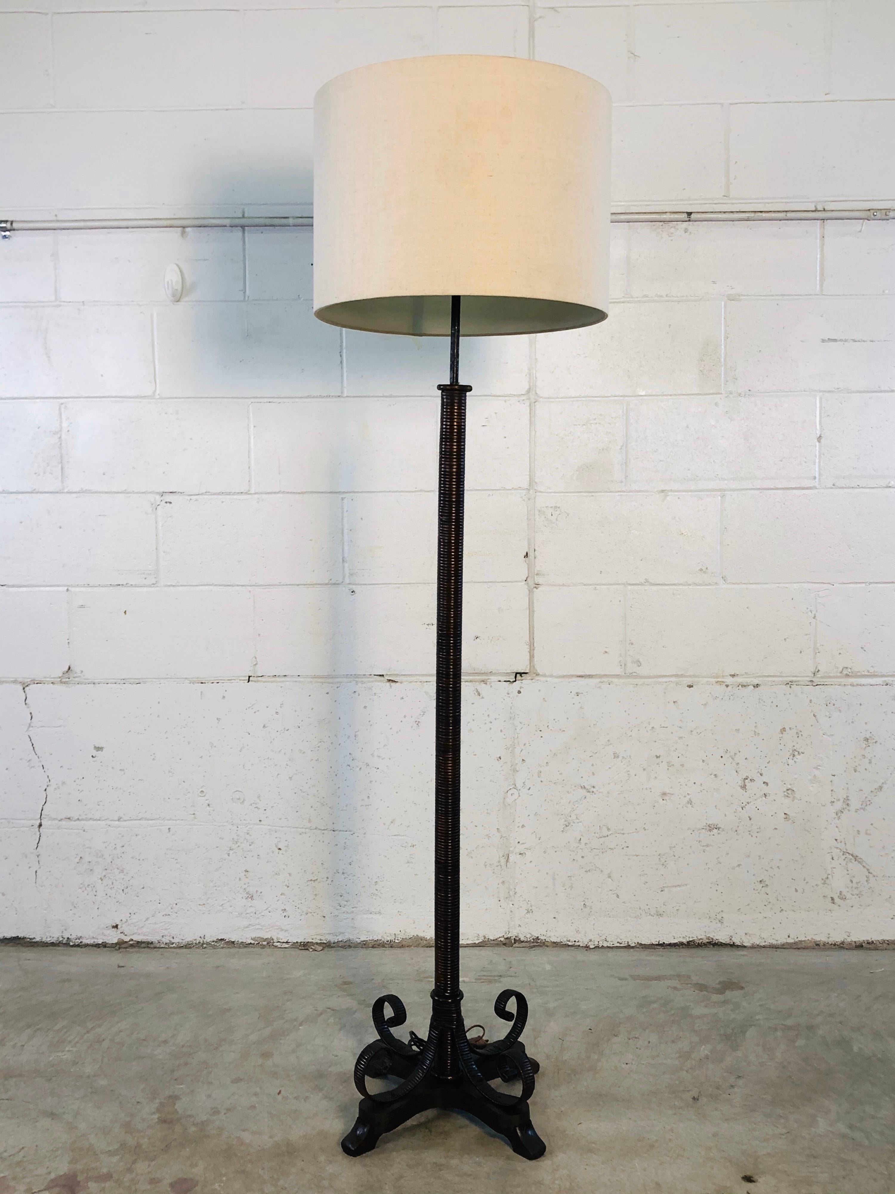 Vintage 1920s Heywood-Wakefield Rattan wrapped floor lamp from the Chicago showroom. This rare lamp is wired for the US and in working condition. The entire base is wrapped in rattan and has a wood base. Comes with a partial label. Shade is not