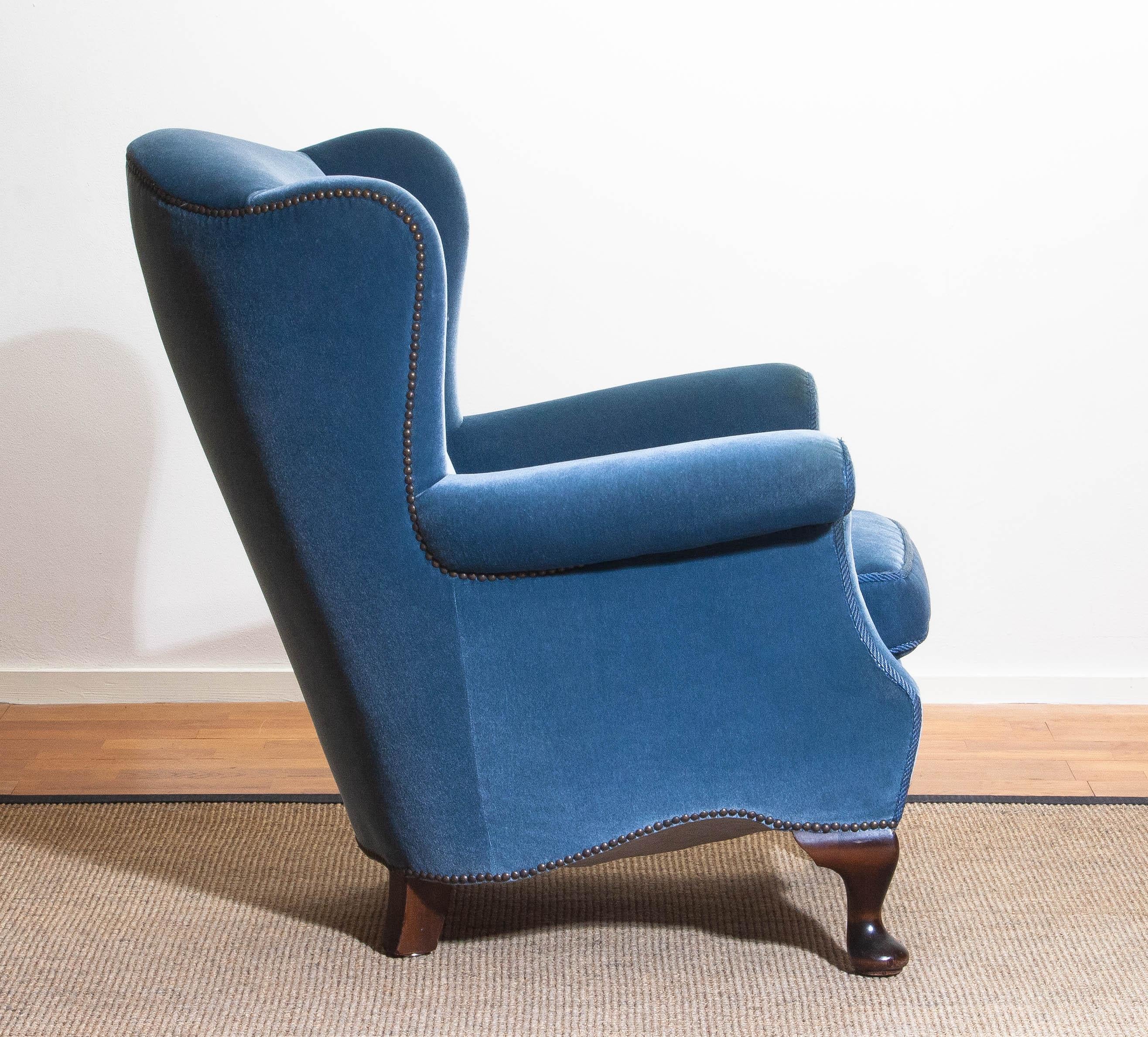 Unique and extremely beautiful Hollywood Regency club chair in blue velvet from the 1920s.
The chair is completely restored in 1987 (only original materials are used).
The overall condition of this chair is very comfortable and good condition.
  