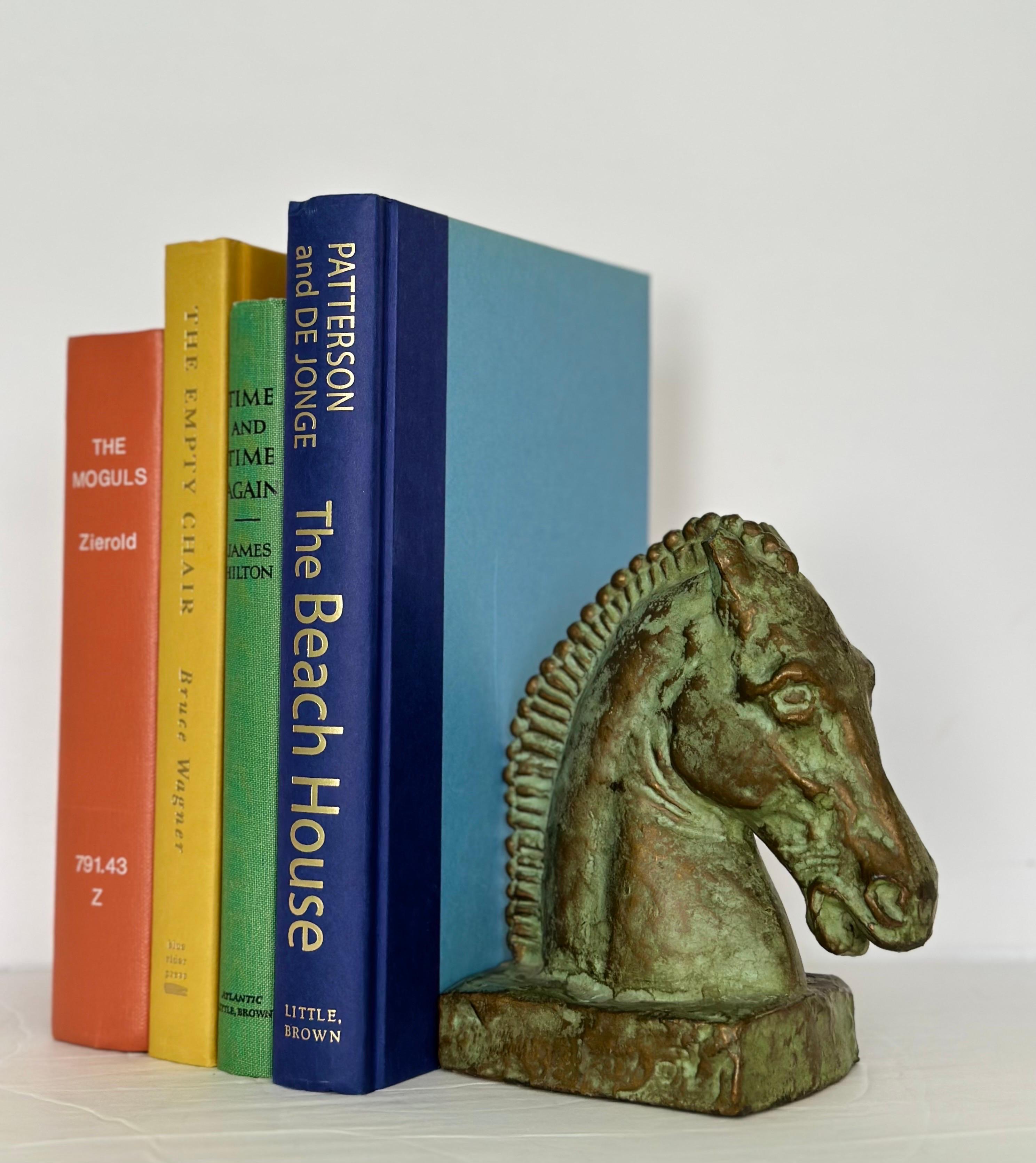 We are very pleased to offer a beautiful pair of bookends, circa the 1920s.  Crafted with meticulous attention to detail, these bookends feature the charming and iconic motif of horse heads. Their metal construction showcases a stunning finish,