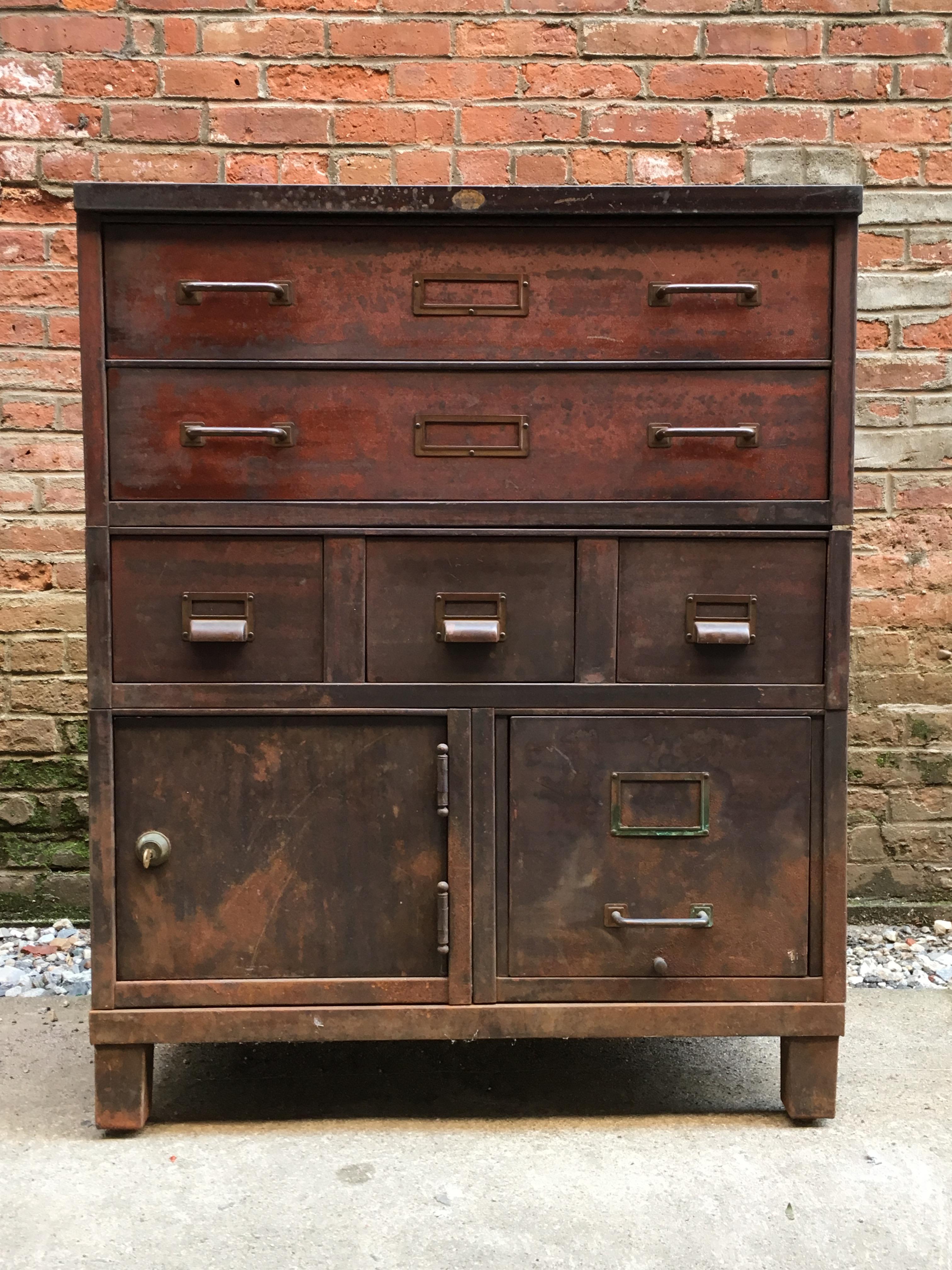 Heavy duty stacking steel utility cabinet. The cabinets are five separate pieces two long drawers over three smaller drawers over a drawer file cabinet, a locking cabinet and ending with the base. The interior of the base was forged in Bethlehem,