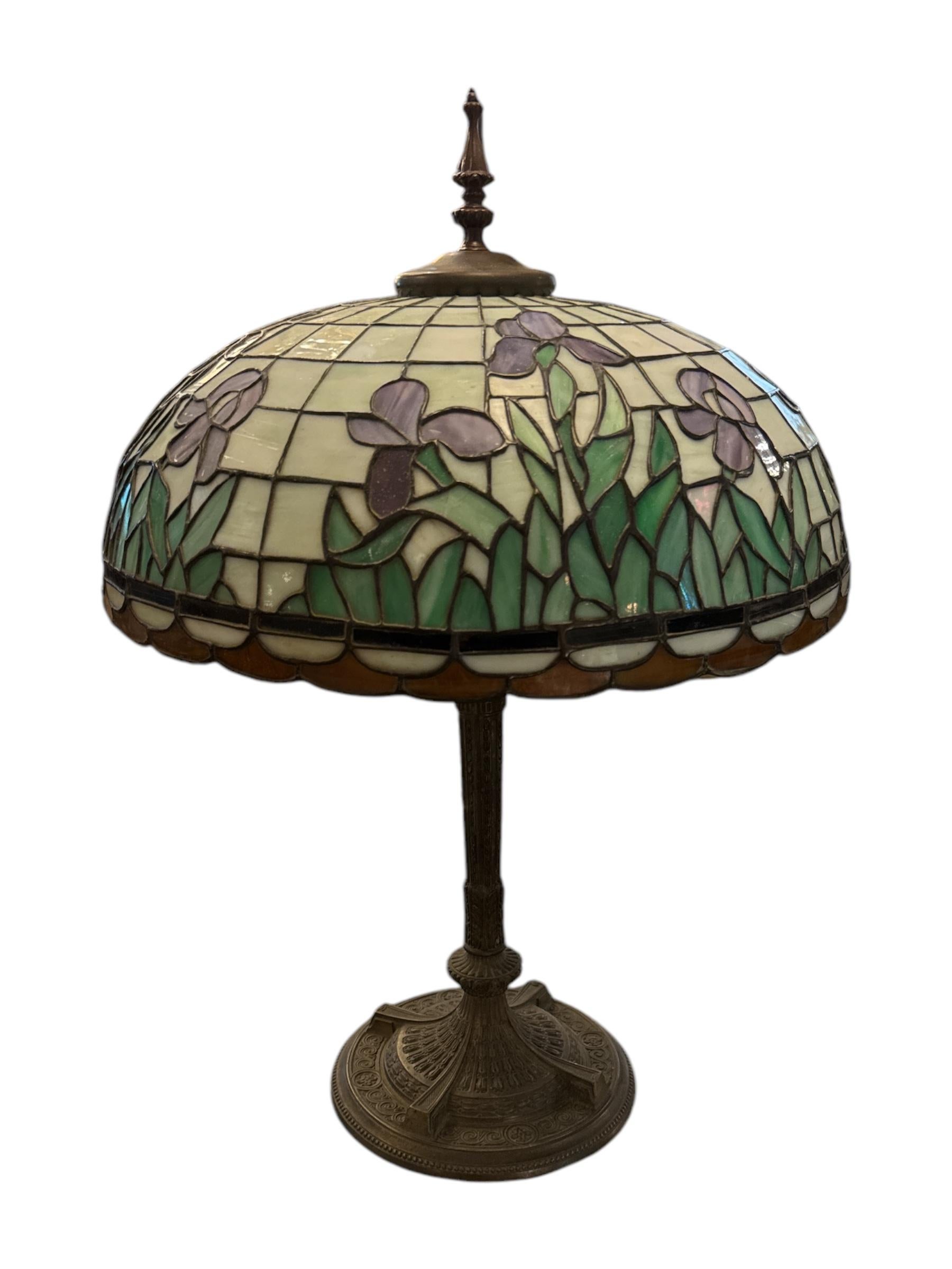 Add a touch of vintage elegance to your home with the 1920s Iris Head Table Lamp. Inspired by the Art Deco era, this striking lamp features a beautifully detailed head adorned with delicate flowers and grasses that evoke the natural beauty of the