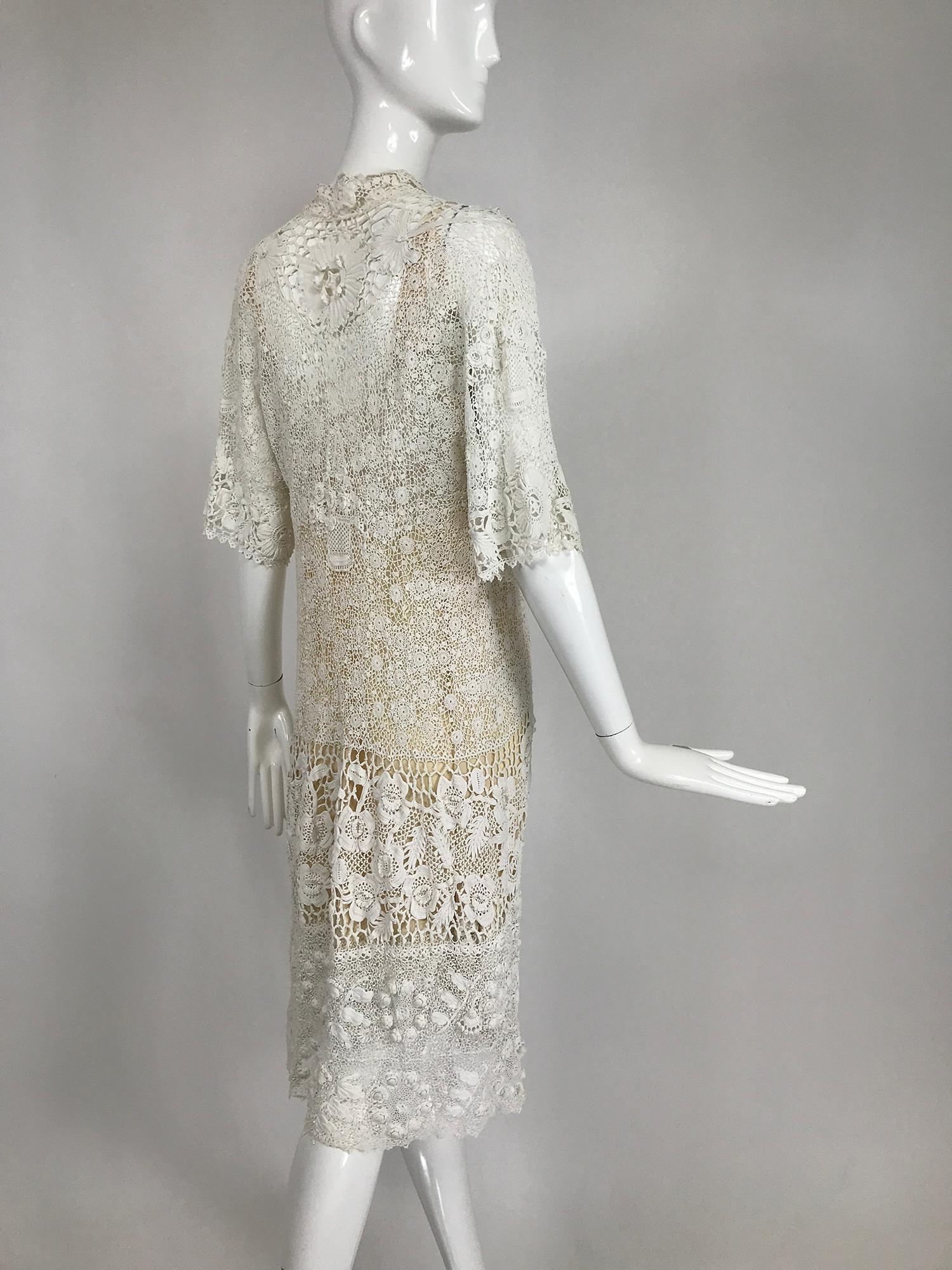 1920s Irish Lace hand crocheted wedding dress or day dress together with the original silk and lace slip. This beautiful dress features all the finest examples of this art, large scale three dimensional flowers that bloom throughout the design, fine
