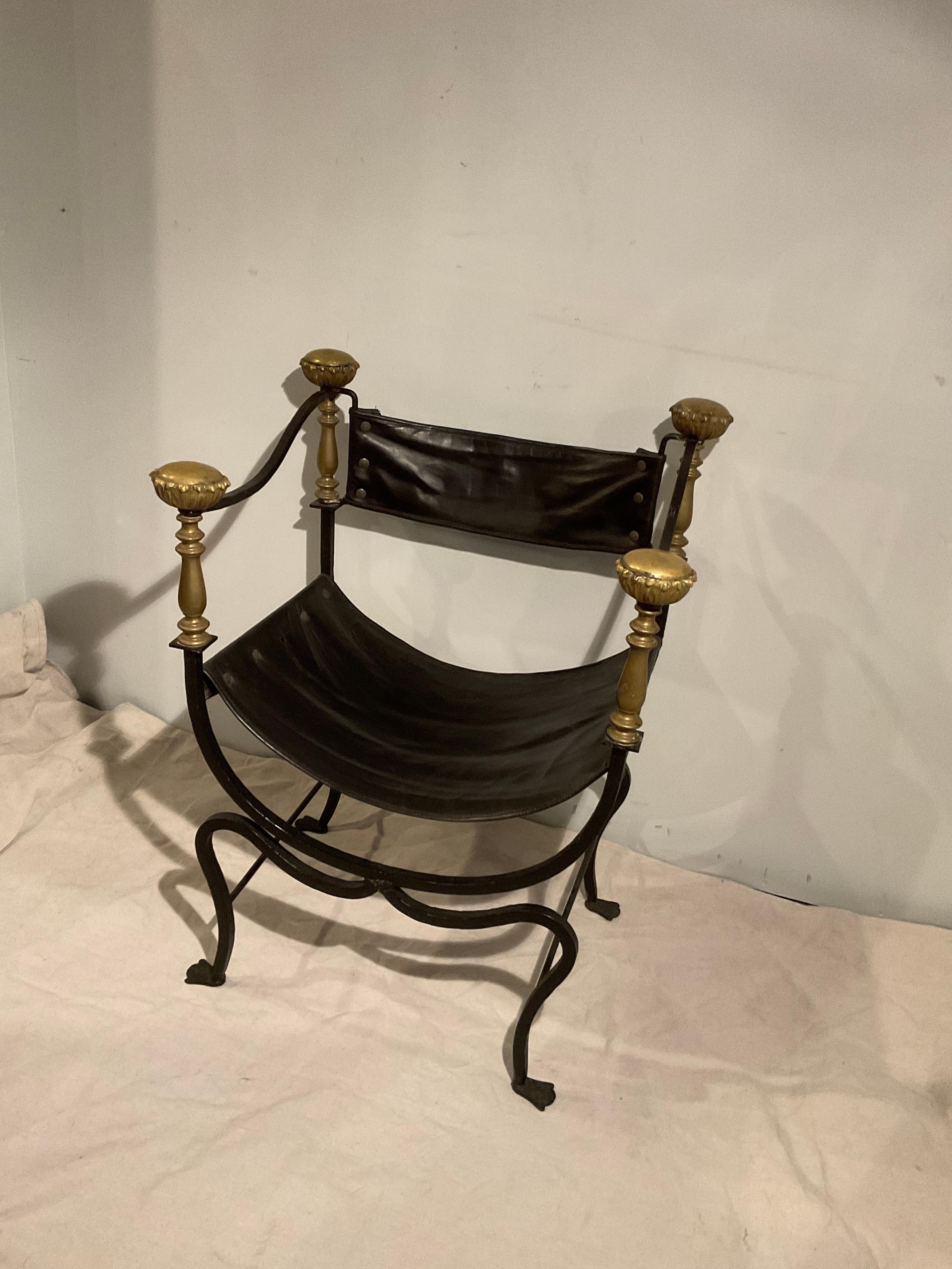 1920s Savonarola chair. Iron and brass. One rivet missing in vinyl upholstery.