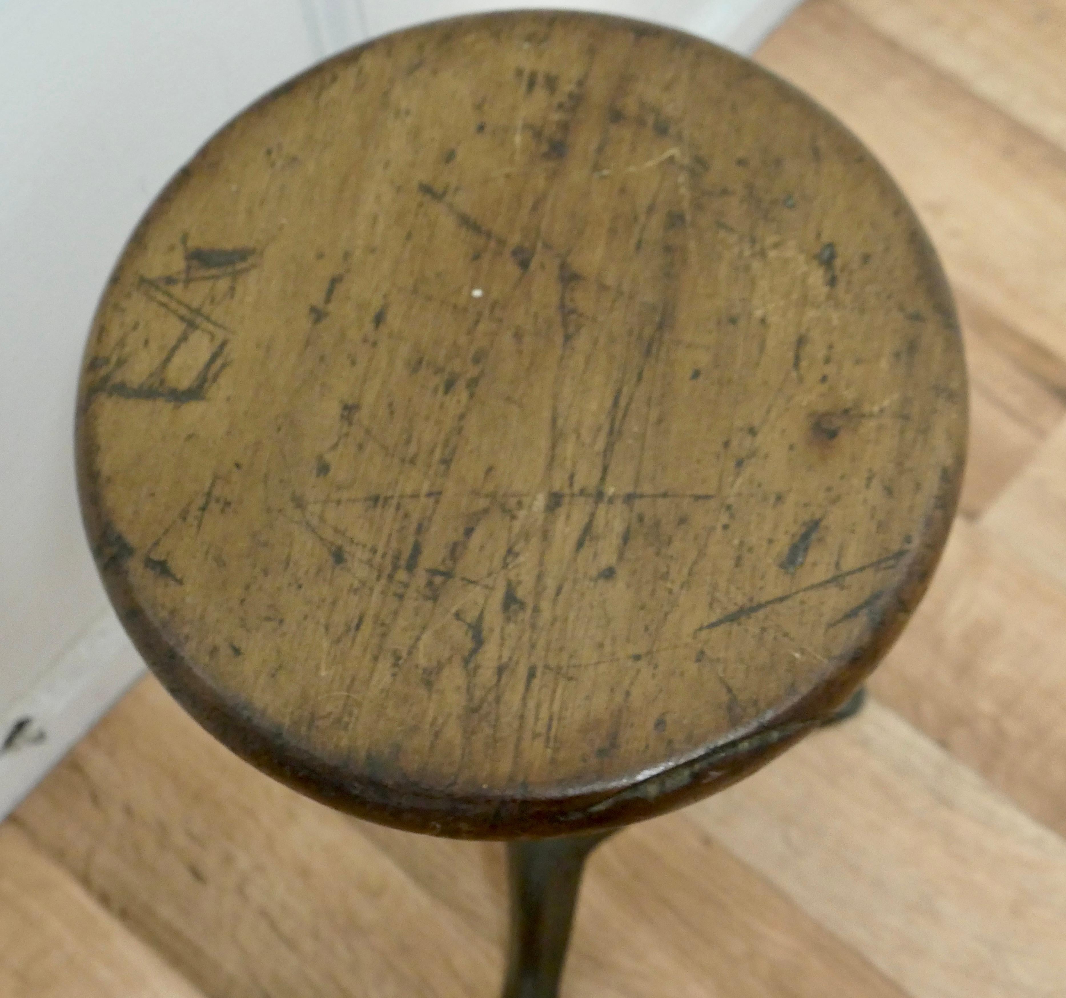 1920's Iron and pine machinist’s revolving stool.


An original Industrial machinist stool with heavy cast iron base and a 1.5” thick, round wooden seat.
The stool revolves on a giant screw making it adjustable in height.
The stool is in good