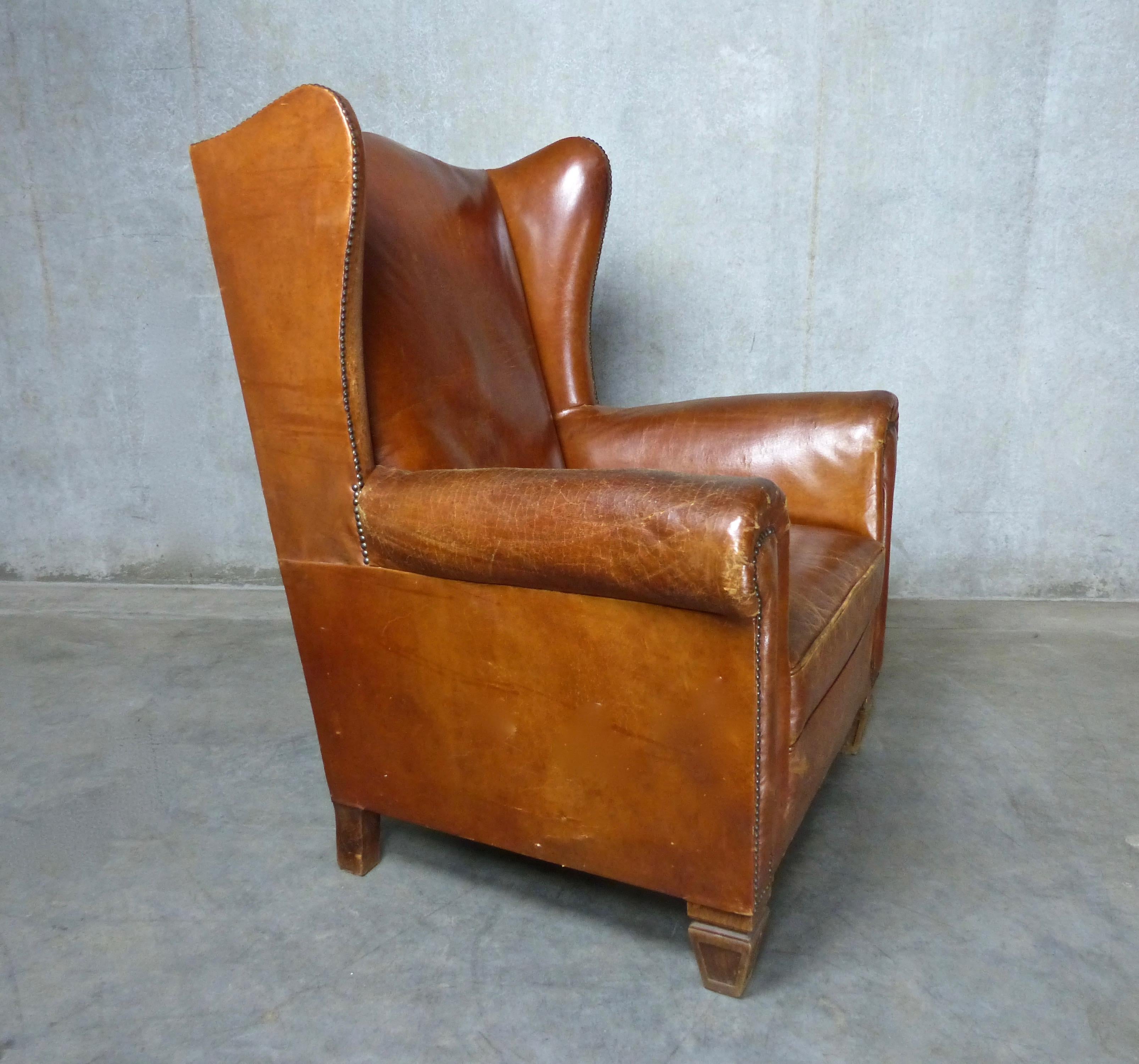 Beautiful patina on a classic wingback armchair in caramel-colored Italian leather. Great proportions; carved wooden feet, and some nail head trim. Comfort and style!
Dimensions: 40” H x 29” W x 34” D.
 