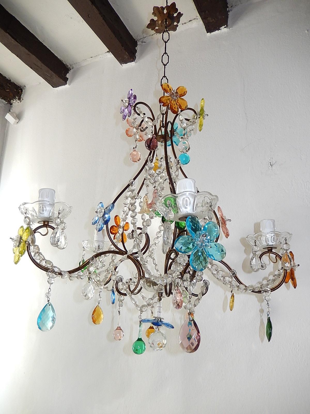 Housing 5 lights, sitting in crystal bobeches, dripping with crystal prisms. Will be rewired with appropriate sockets for countr and ready to hang. Beaded crystal swags throughout. Adorning crystal coloured prisms in a flower shape and Murano glass