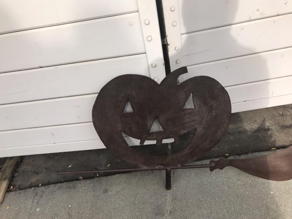 1920s sheet iron weather vane of a jack- o - lantern on a witches broom weather vane. This iron vane has a wonderful aged patina. This weather vane was found in the mid-west.