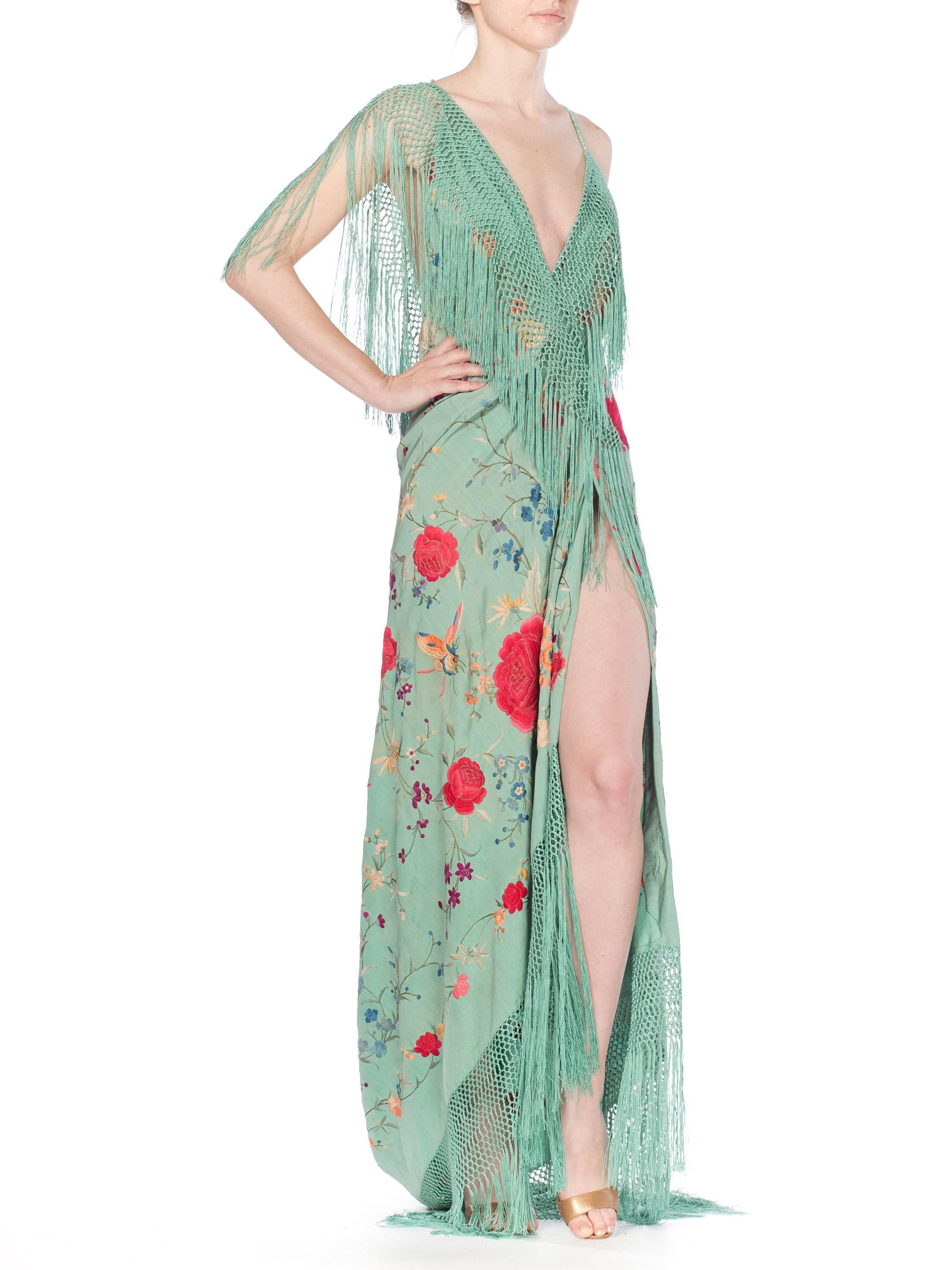 This gown is made from an antique piano shawl in the most beautiful Chinese Jade green with wonderful flowers and butterflies embroidered all by hand. The gown has a high slit and low back with a train. The train can be picked up and latched to a