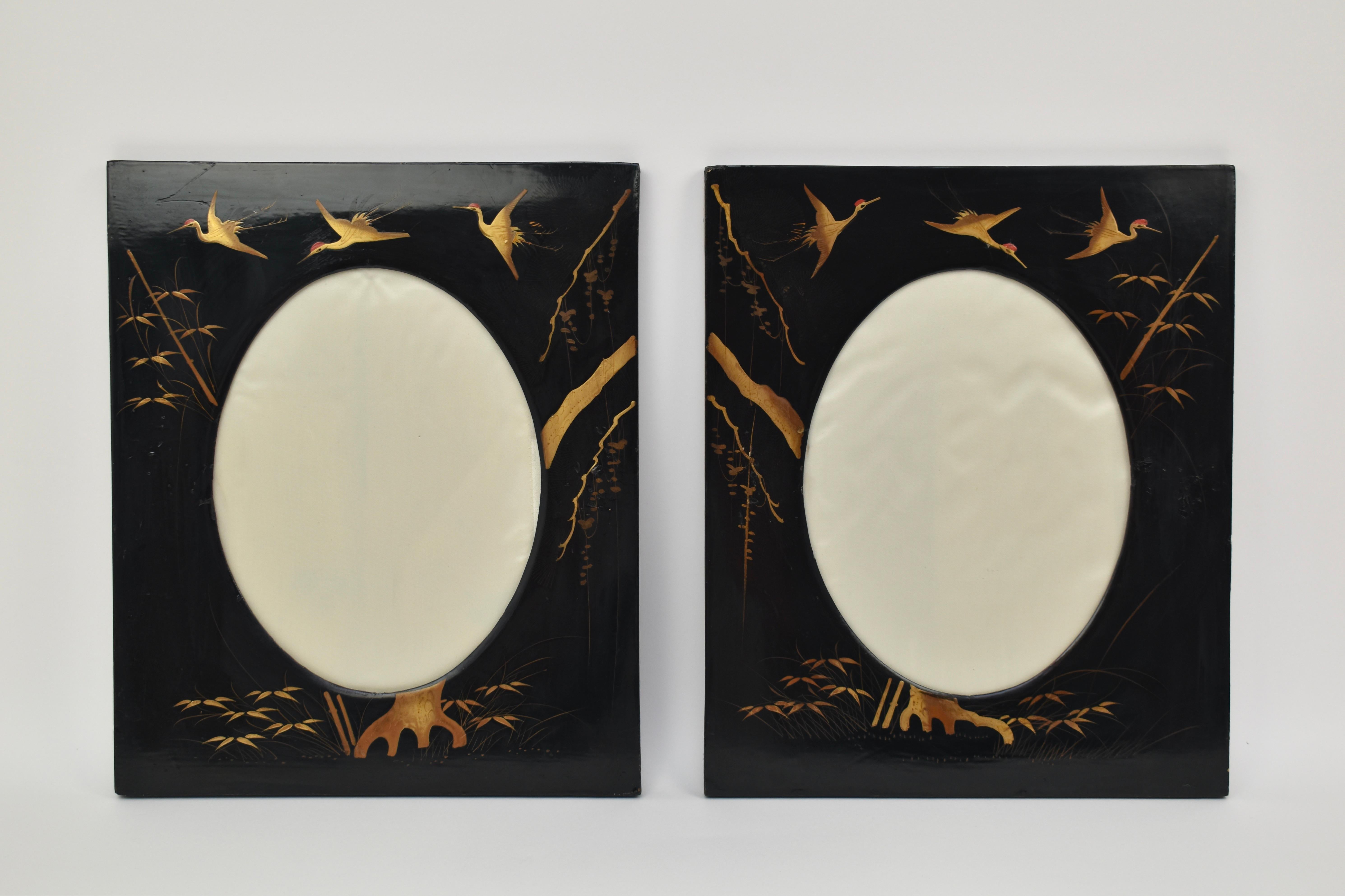 Set of two 1920s Japanese black lacquer picture frames. These frames are made from wood, and are decorated with gold crane birds and reeds. Inside is a white satin backdrop, and glass. Great condition, some traces of wear as can be seen on the