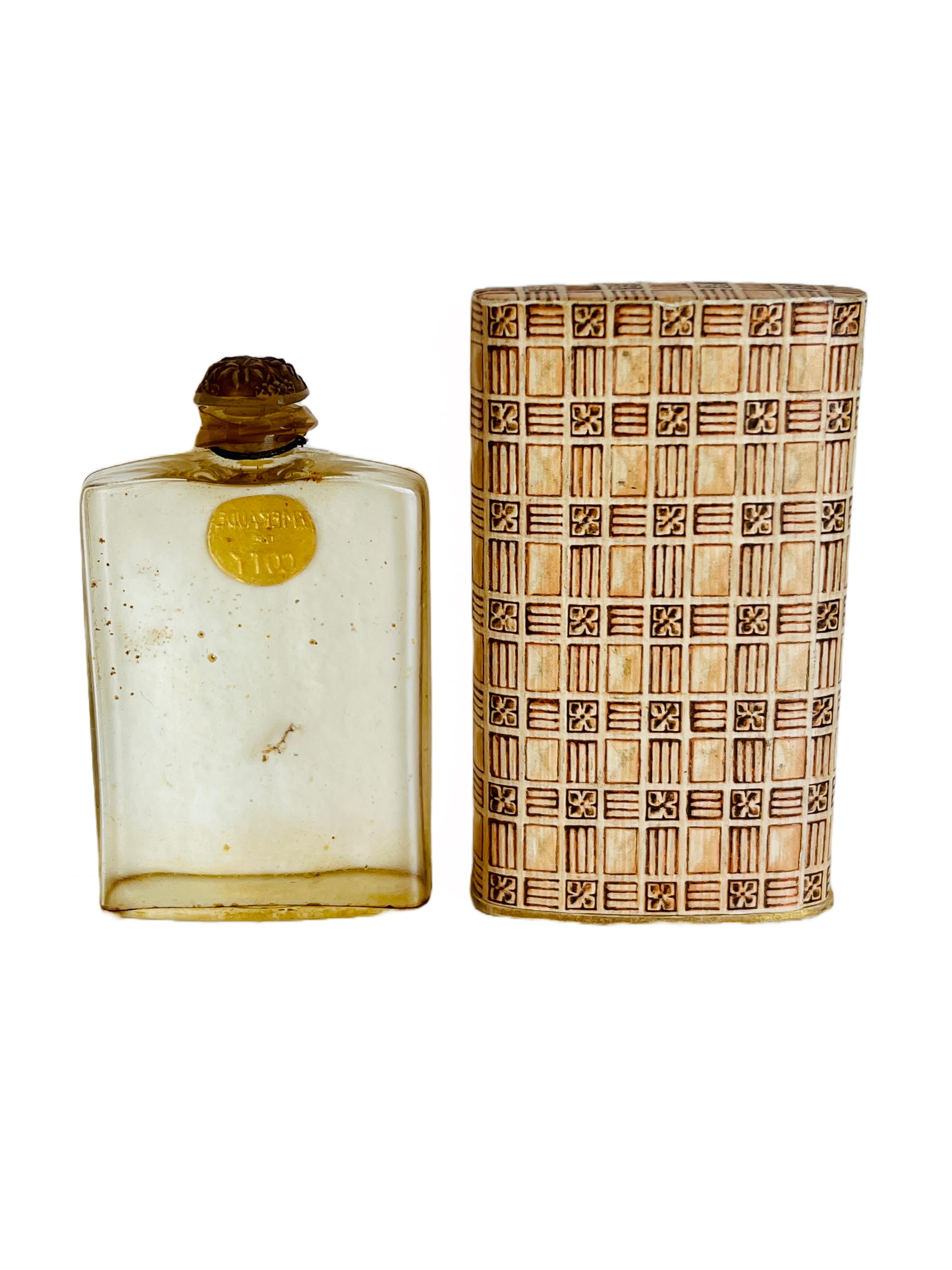 This empty Lalique perfume bottle once contained one of Coty's earliest creations, 