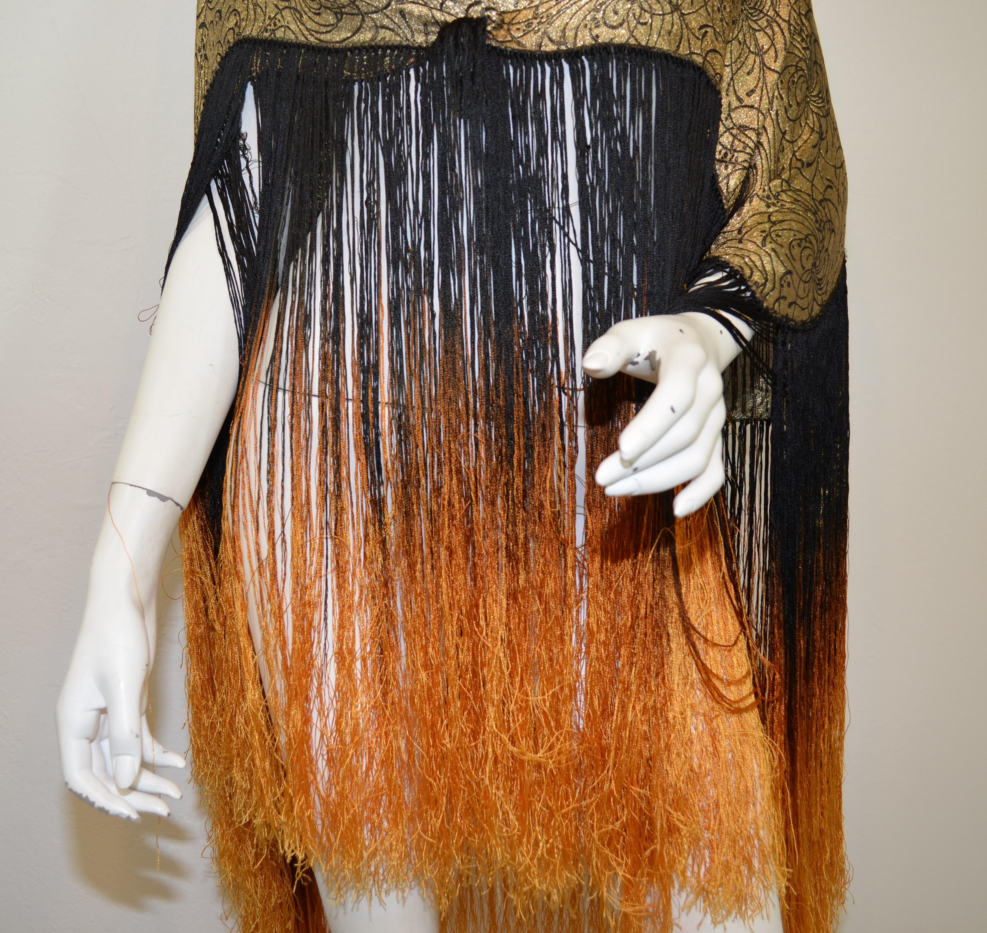 Beautiful 1920's gold and black lame shawl featuring long, ombre fringing. Shawl is in wonderful condition considering age, with some minor tarnishing as photographed. 

Measurements:
Length 45 x 34'' (not including fringe), fringed ends measure 20''