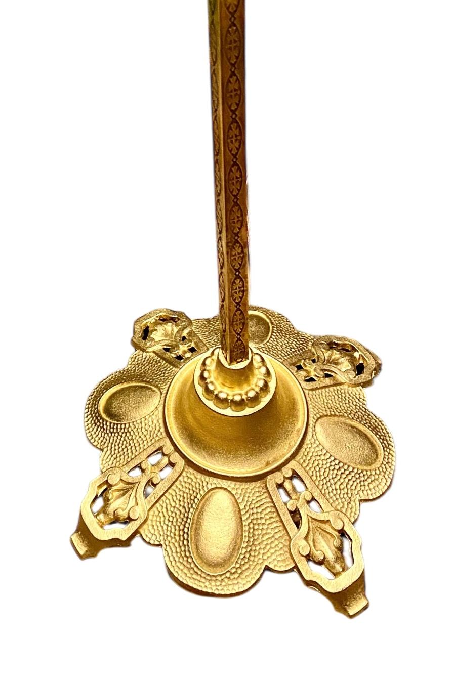 An antique American 1920 engraved brass, detailed gold metal lamp standard having an agate ball. Sitting atop is a high quality slag and stained glass Tiffany reproduction in the “tulip” pattern. 
Creates a very atmospheric setting in a traditional