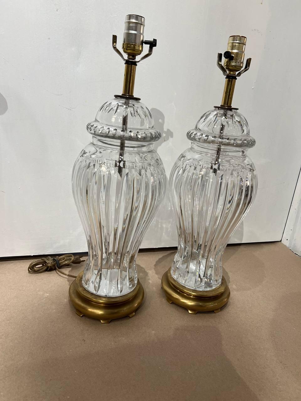 A pair of circa 1920's large cut crystal table lamps with bronze base. Available matching pair, but with different base