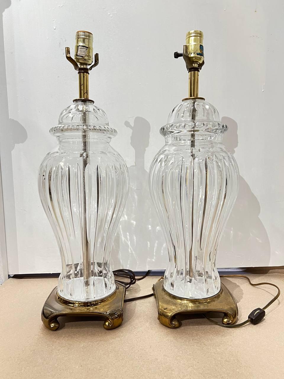 A pair of circa 1920's large cut crystal table lamps with bronze base