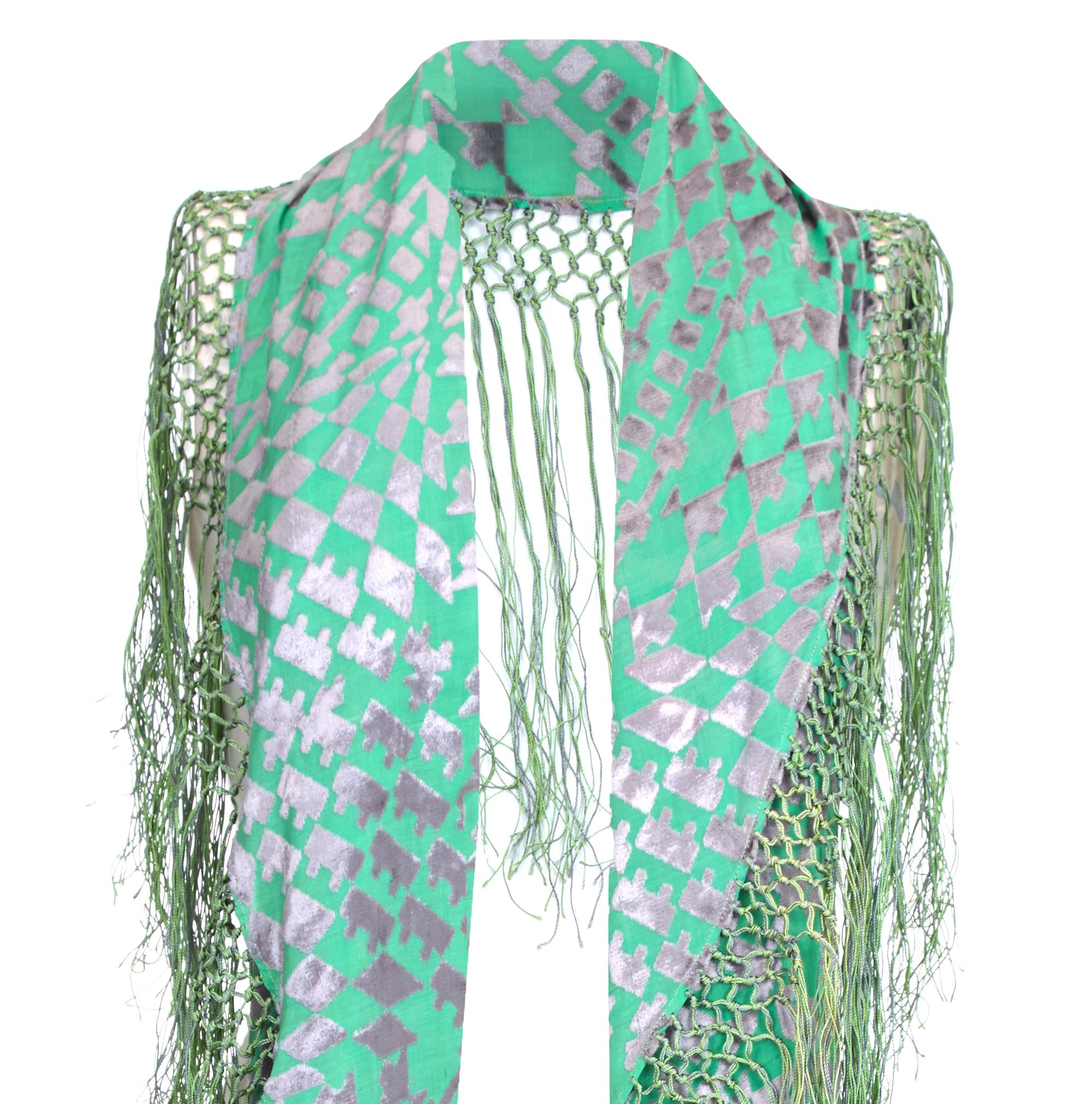 Extraordinary and very rare vintage 1920s shawl with jade green and silver burn out panne silk velvet in an art deco style geometric pattern.  Semi-circle in shape, the shawl has green and silver tassels around the curved edge with the plain edge to