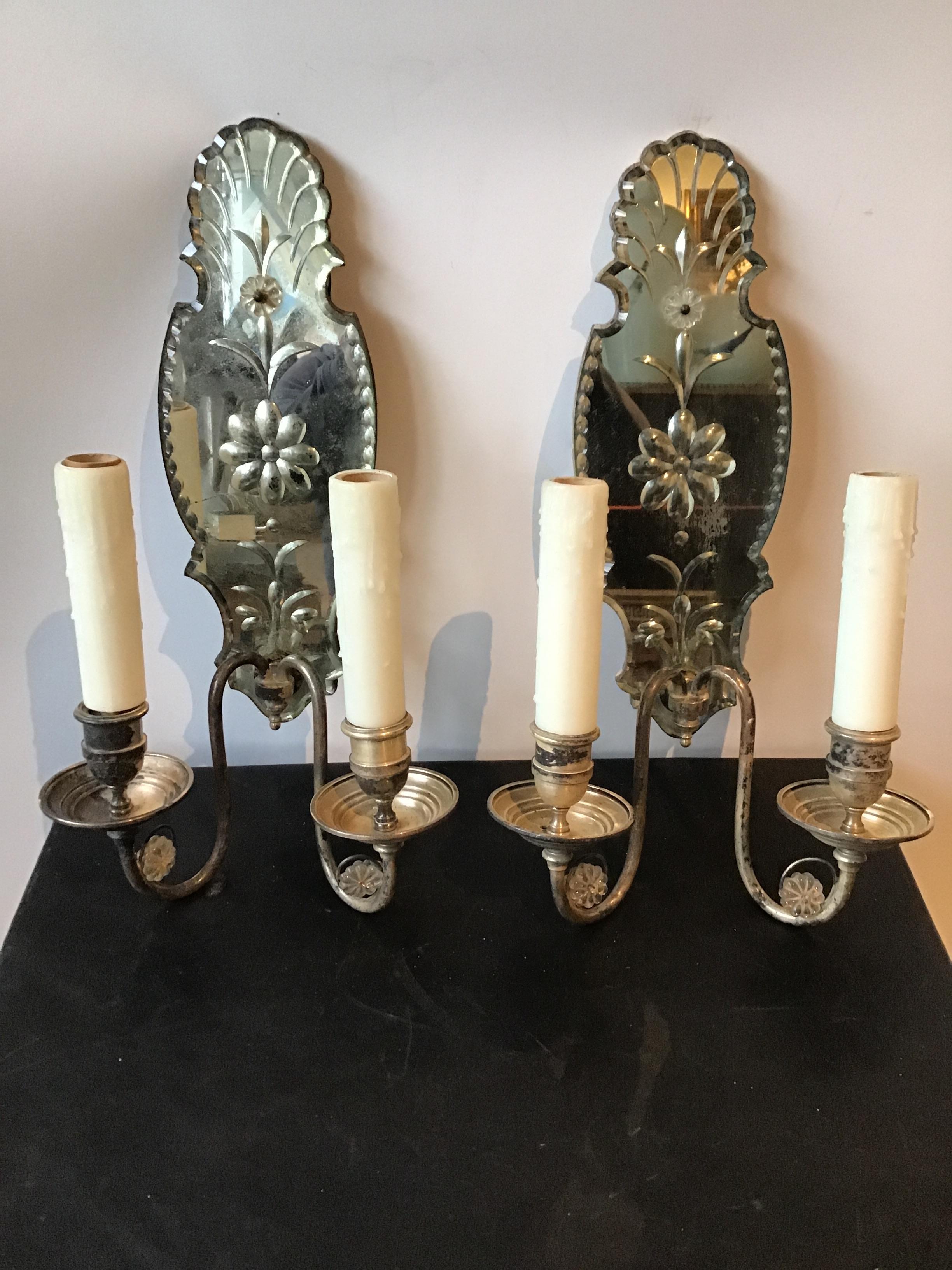 Large 1920s mirrored sconces with silver plate arms. Silver plate is distressed in areas. Purchased from a Greenwich, Connecticut mansion.