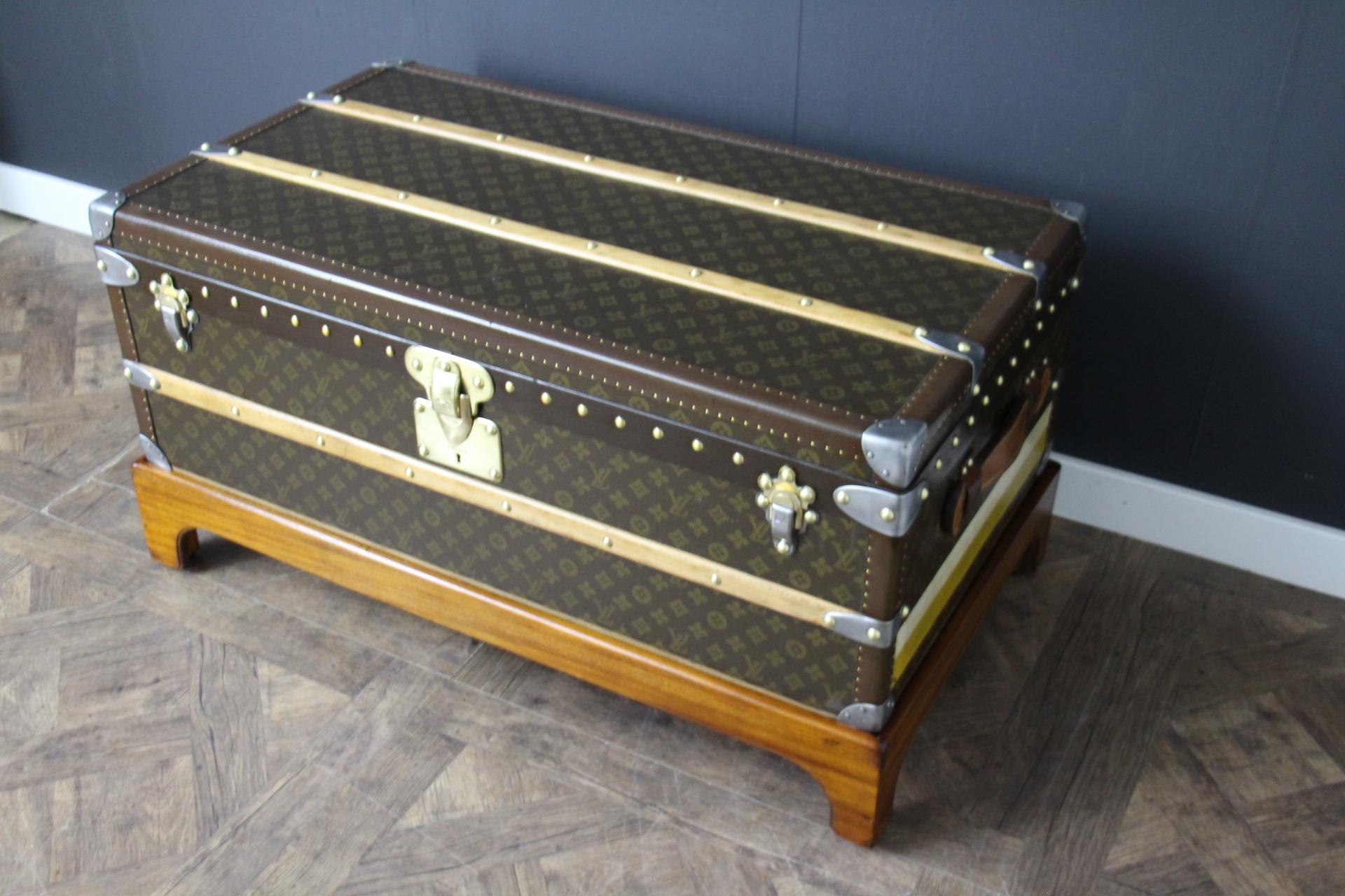 This very nice Louis Vuitton trunk features hand stenciled monogram canvas , chocolate brown color lozine trim and Louis Vuitton stamped solid brass locks and brass and steel clasps, as well as large leather side handles. Its patina is warm and
