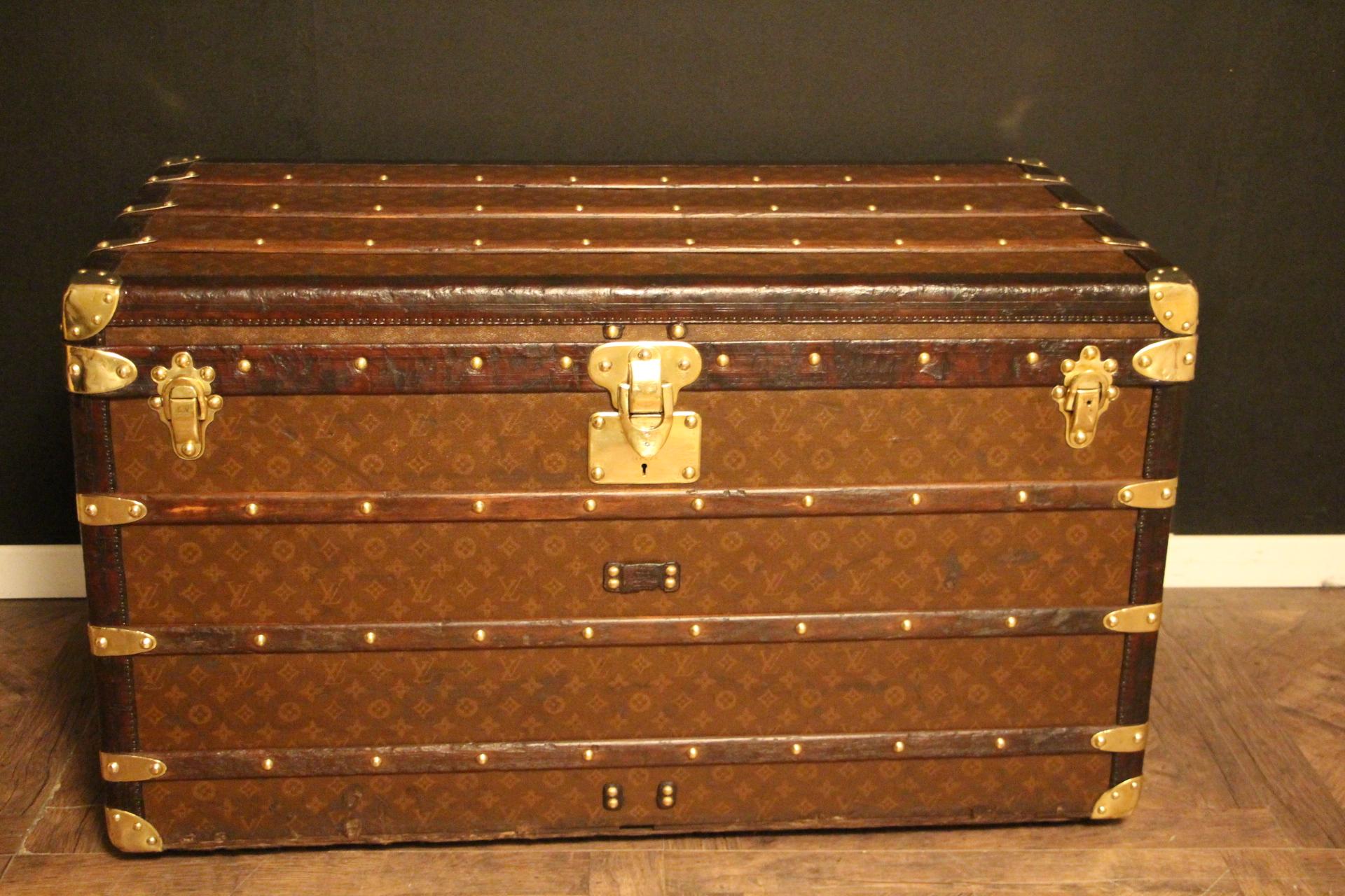 This superb Louis Vuitton steamer trunk features stenciled monogram canvas, deep chocolate color leather trim, LV stamped solid brass locks and studs as well as solid brass side handles and brass corners. It has got a beautiful original warm patina