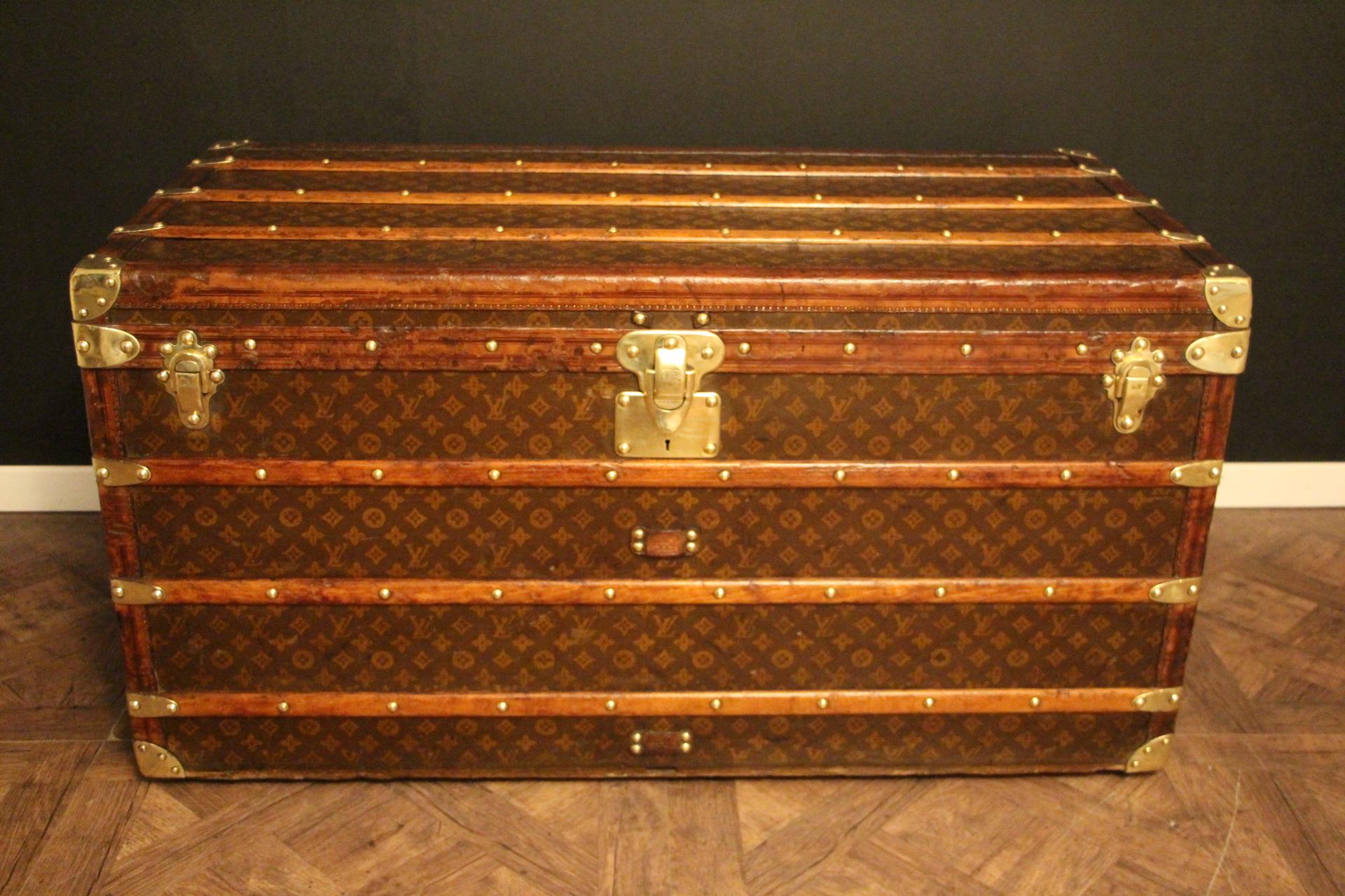 This superb Louis Vuitton steamer trunk features stenciled monogram canvas, deep chocolate color leather trim, LV stamped solid brass locks and studs as well as solid brass side handles and brass corners. It has got a beautiful original warm patina