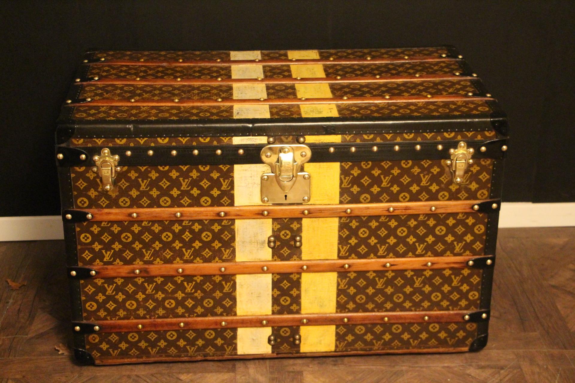 This Louis Vuitton trunk features stenciled canvas, deep black lozine trim, engraved LV black steel side handles, solid brass Louis Vuitton stamped brass lock and clasps as well as Louis Vuitton stamped brass studs. 
White and yellow customized