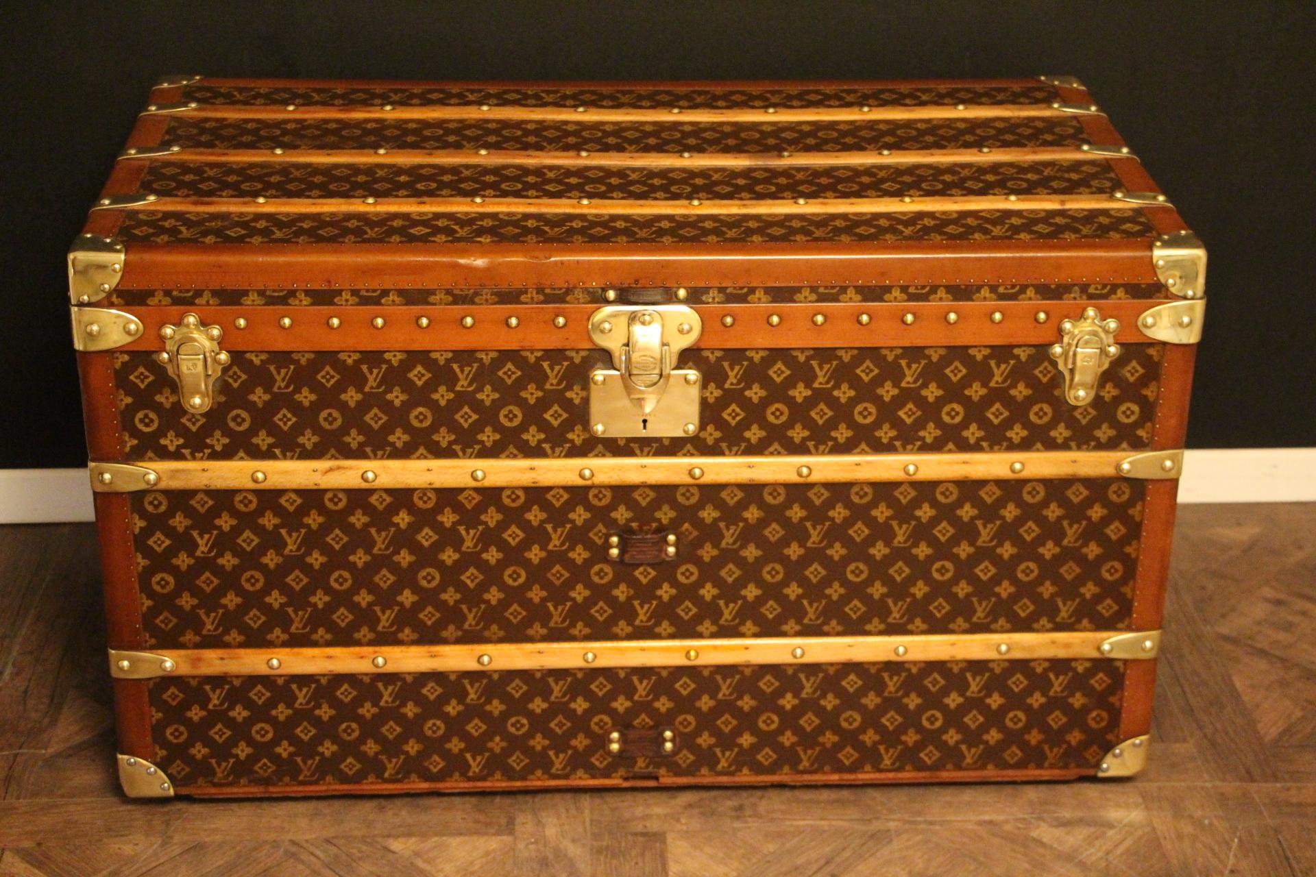 This superb Louis Vuitton steamer trunk features stenciled monogram canvas, honey color lozine trim, LV stamped solid brass locks and studs as well as leather side handles and brass corners. Its customized painted white and turquoise blue stripes