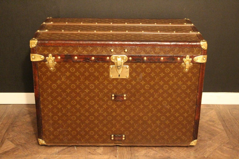 Superb Louis Vuitton steamer trunk featuring stenciled canvas, all leather trim in deep chocolate color, solid brass Louis Vuitton stamped clasps, lock and studs, solid brass corners and solid brass LV stamped side handles. Measure: 76