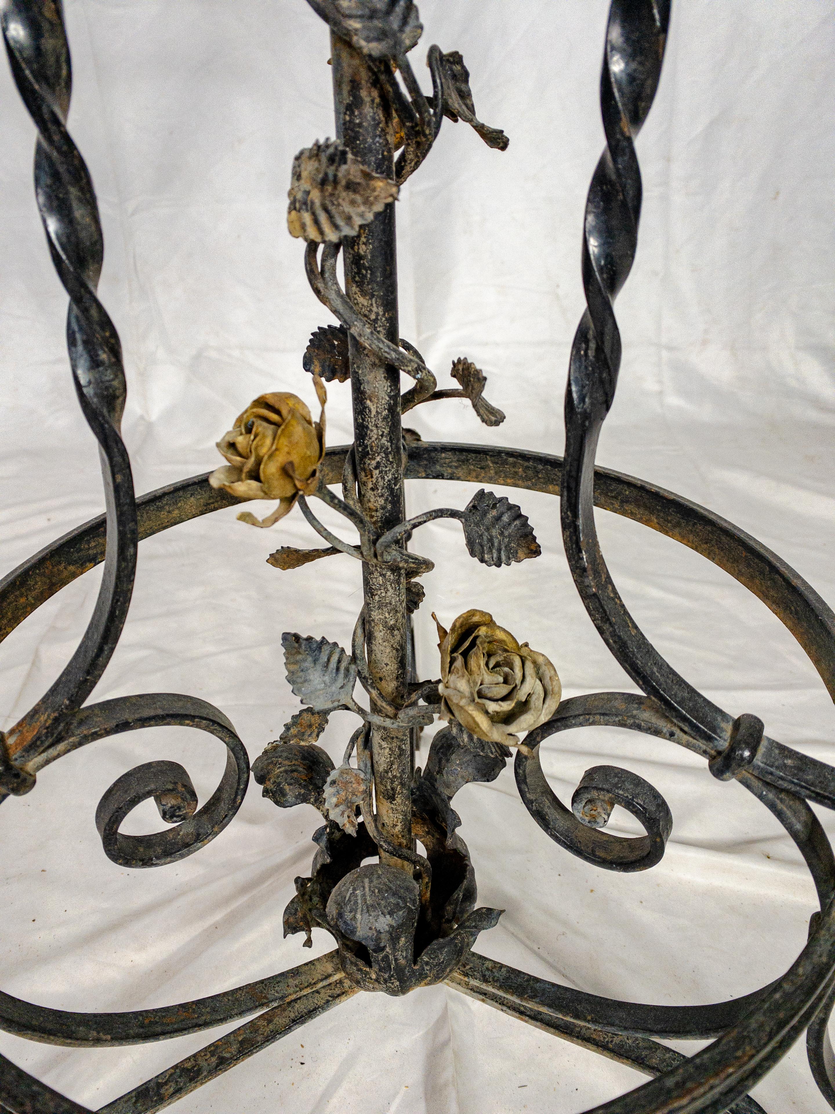 The 1920's Louis XV style French Plant Stand is a captivating and sophisticated piece of furniture that combines the elegance of the Louis XV era with the charm of the 1920s. Crafted from forged black painted iron, it exudes a sense of sturdiness