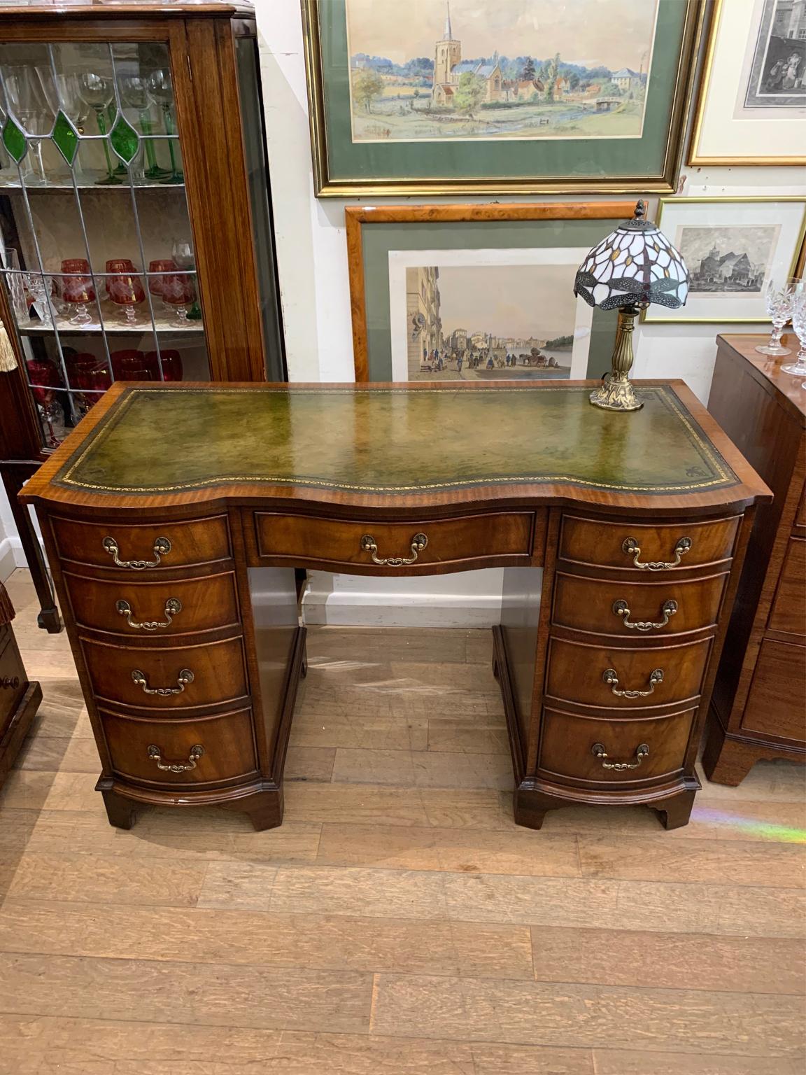 1920's Mahogany serpentine bow-shaped pedestal desk with a leathered writing surface and nine drawers, all with fitted brass swan neck handles and lined mahogany drawers.

Circa: 1920

Dimensions:
Width: 45 inches – 115 cms
Height: 29.5 inches