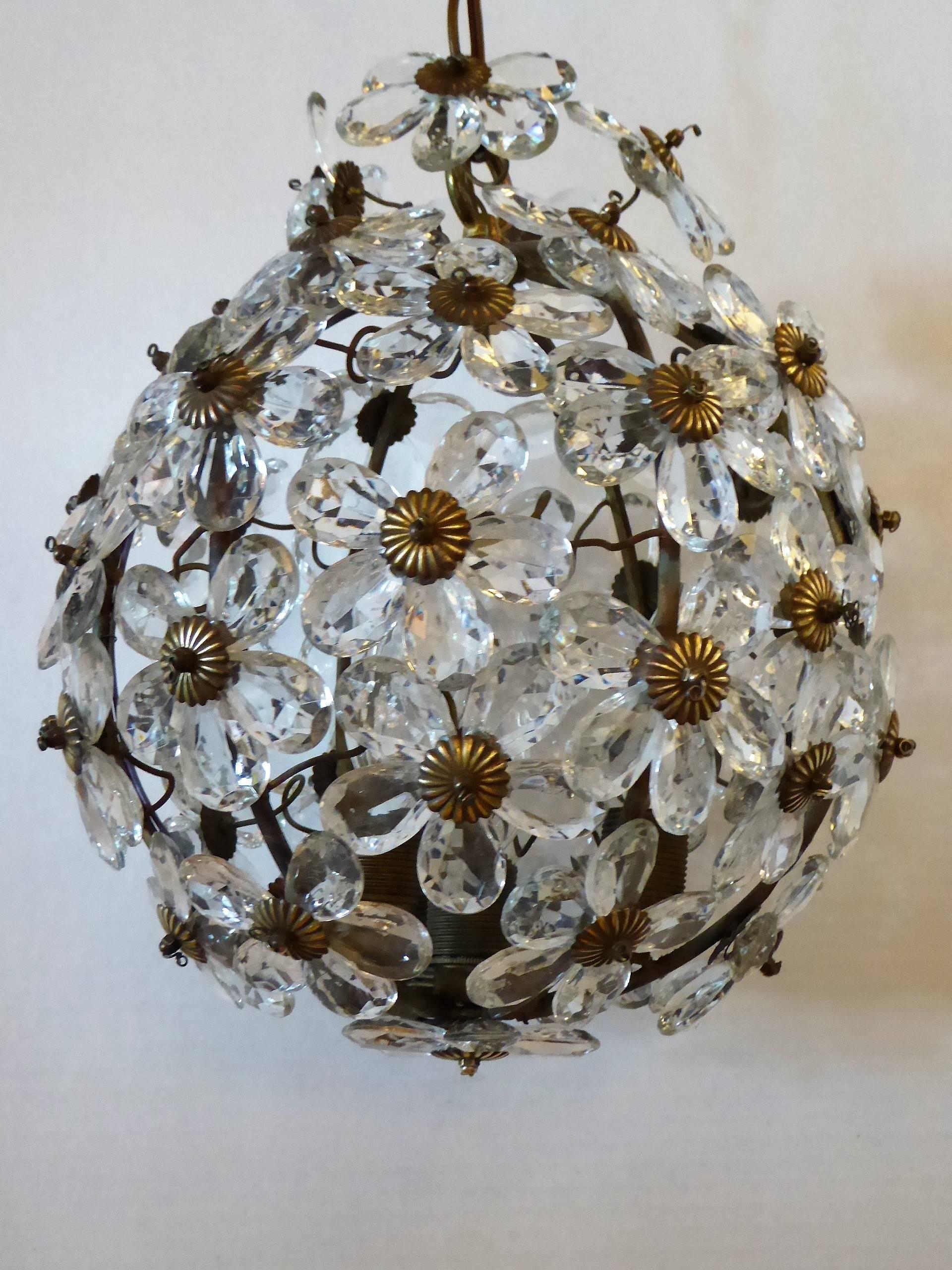 Precious 1920s era Baguès ball form chandelier of crystal petal floral design. With four internal candelabra bulb lights. All crystals intact, no losses. Iron body with old gold patina. Beautiful!
Measurements: 30 inches high with 16 inches extra