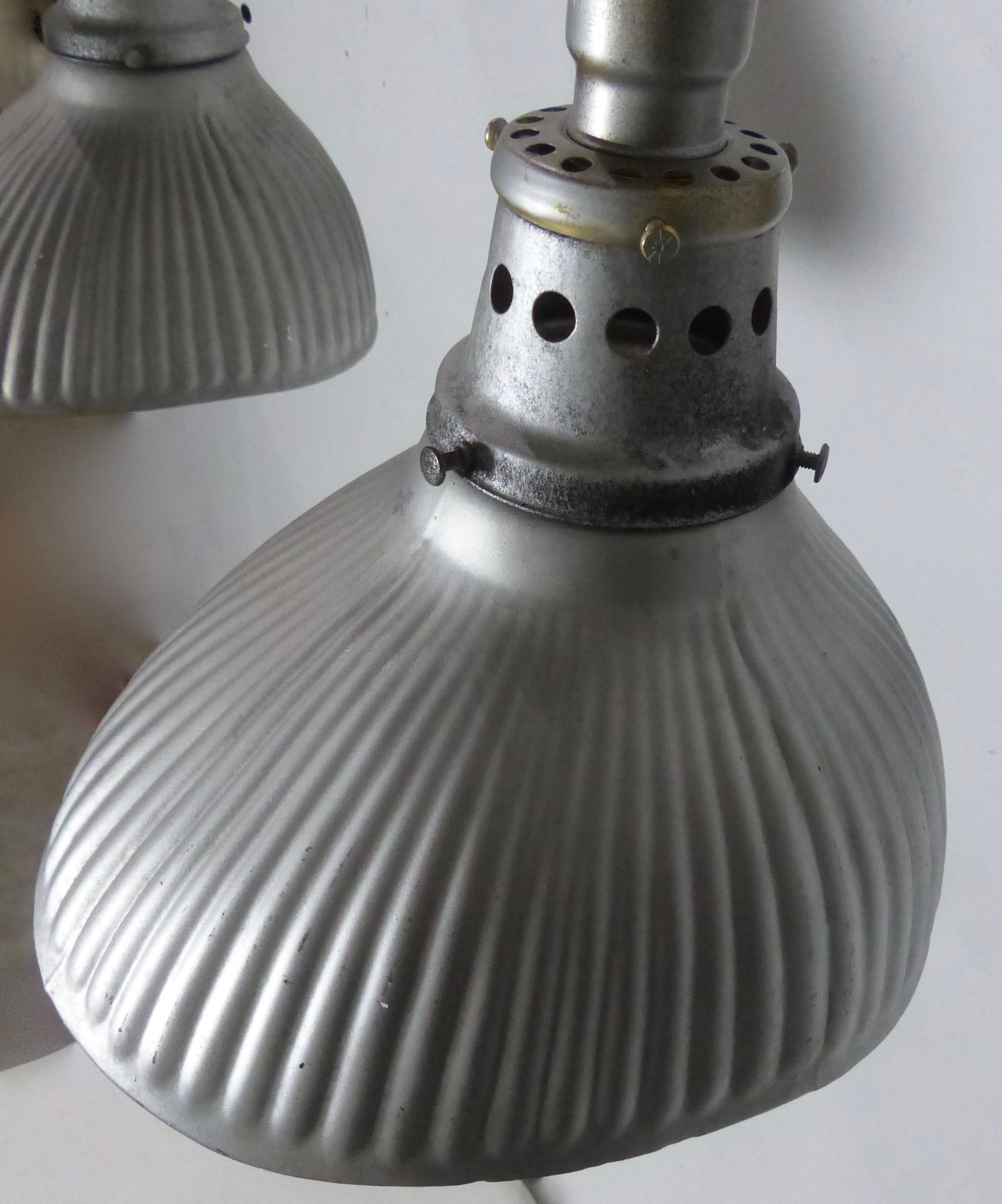 Matched set of three authentic industrial mercury X-ray wall sconces in silver, with original silvered shades. Produced by Curtis Lighting, a Pioneer of indirect lighting, X-ray lights feature metal shades lined with mercury glass, which creates a