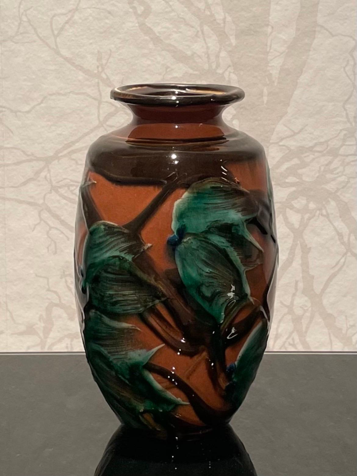 Dies ist die 20 cm hohe dänische Keramikvase aus den 1920er Jahren von Herman Kähler in neuwertigem Zustand. 

Sie ist mit einem balusterförmigen Körper ausgestattet. Es hat eine glänzende Oberfläche, ein schönes glasiertes Kuhhornmuster mit schwarz